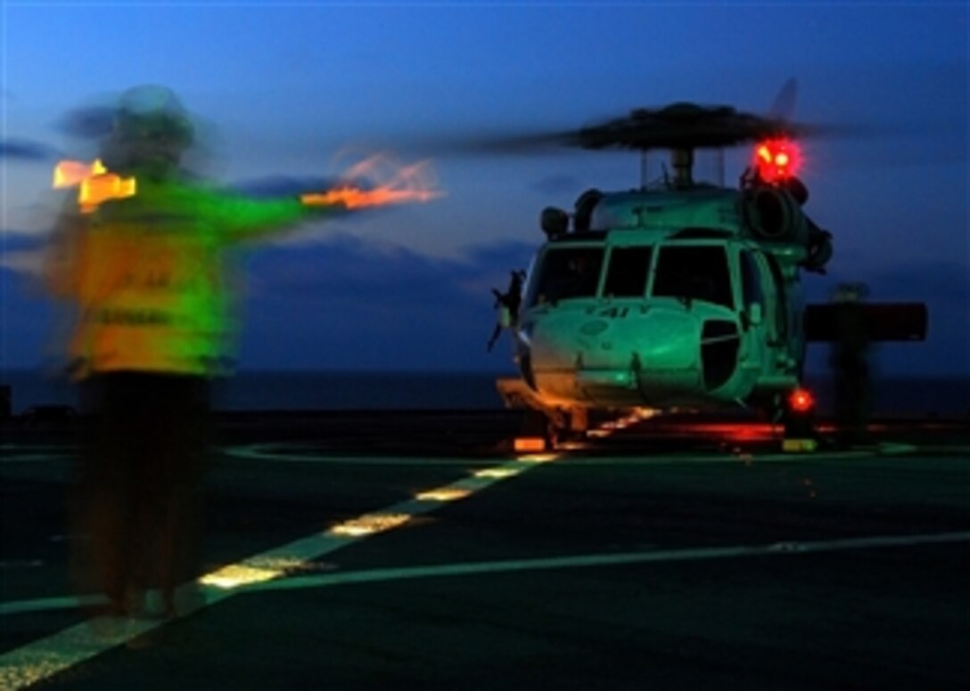 An MH-60 Seahawk helicopter assigned to Helicopter Sea Combat Squadron 28 lands aboard the amphibious command ship USS Mount Whitney (LCC 20) while underway in the Mediterranean Sea after conducting in-flight gun qualifications on Jan. 31, 2009.  The Mount Whitney is supporting Austere Challenge 2009, a joint exercise designed to test U.S. capabilities across the full range of military operations in the European theater.  