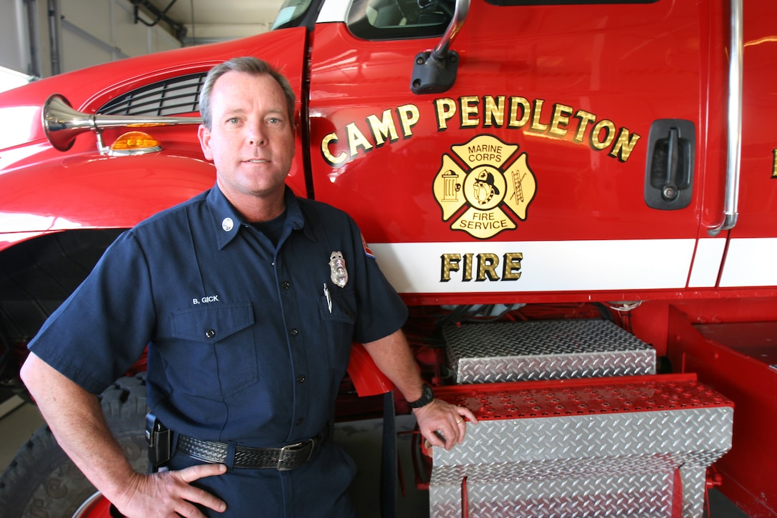Bill P. Gick, fire inspector and public information officer, Fire and Emergency Services, Marine Corps Base Camp Pendleton, is seen above in front of a fire engine at Truck Company 1, Station 1 in the 22 Area. Gick has served with Pendleton’s FES for the last 16 years.
