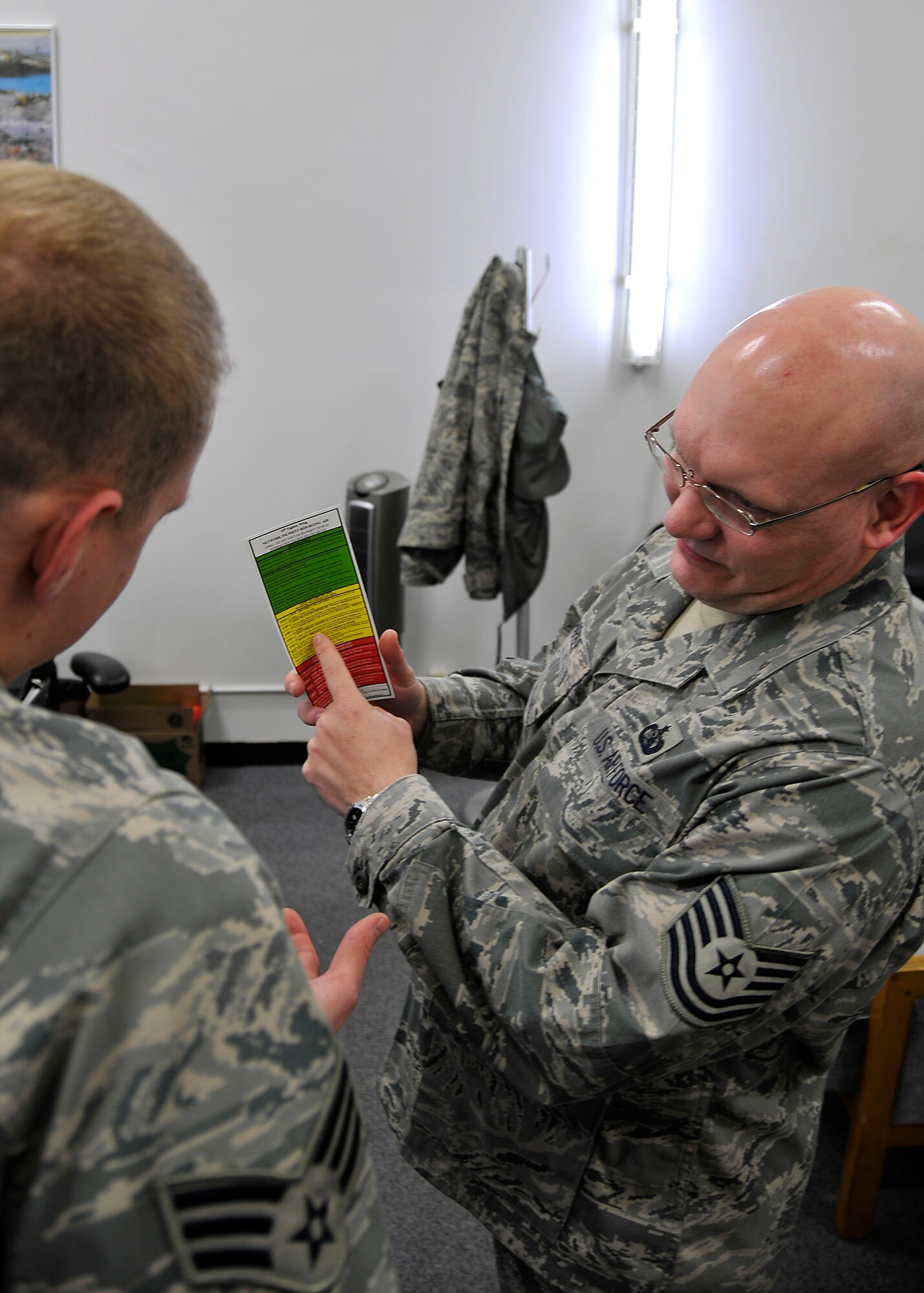 MISAWA AIR BASE, Japan --Tech. Sgt. Thomas Parker, 35th Communications Squadron, Information Assurance NCOIC, shows an Airman the proper way to report a suspected computer virus Feb. 04, 2009.  One of the biggest threats to the local network is an e-mail scam known as phishing. Phishing is an attempt to acquire sensitive information by fraudulent means such as an e-mail designed to look like a bank or other trustworthy companies.  (U.S. Air Force photo by Senior Airman Chad C. Strohmeyer)