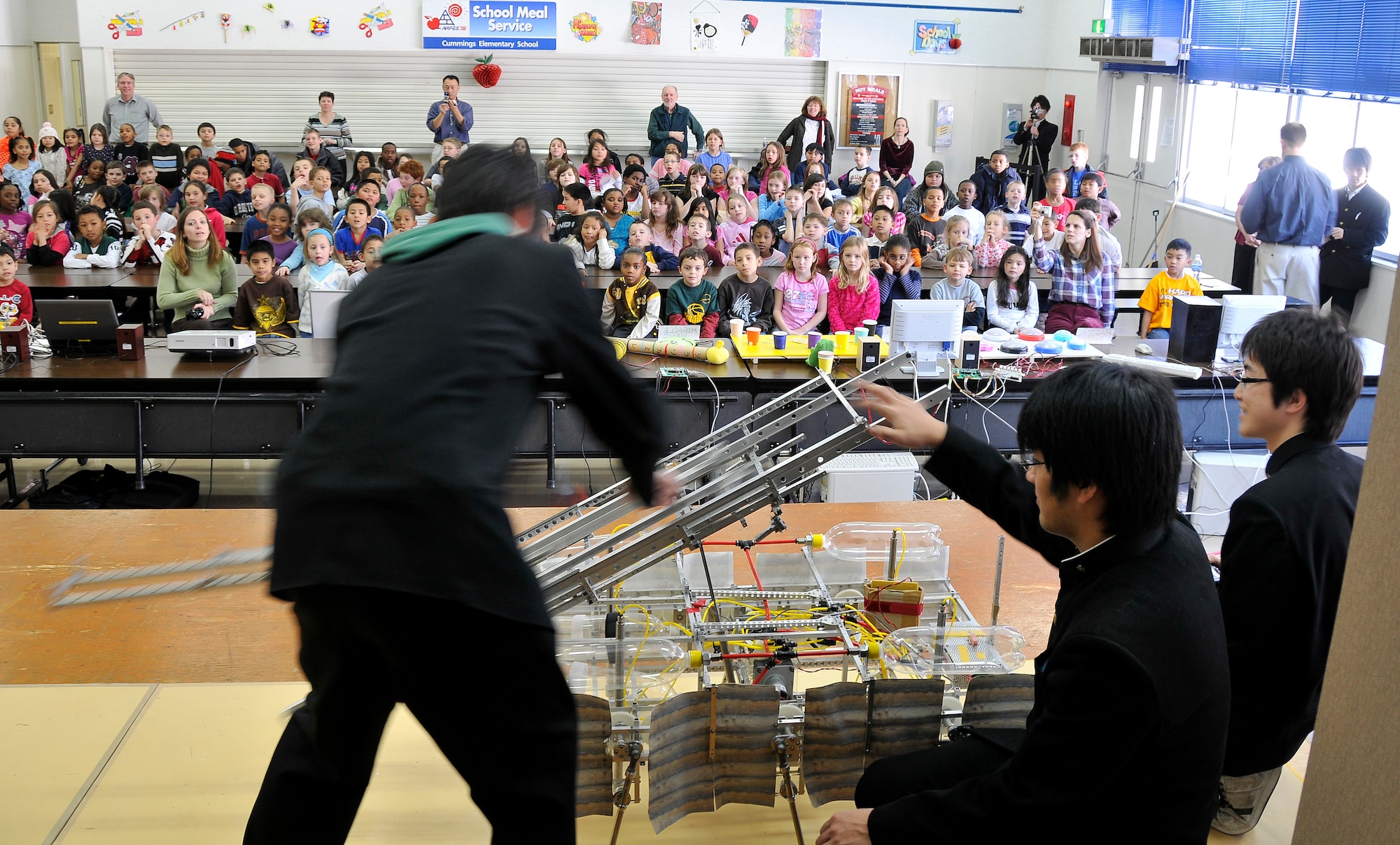 MISAWA AIR BASE, Japan -- Hachinohe National College of Technology students present Cummings Elementary School students,  Feb. 4, 2009, the six and two-legged robots their class created.  This is the second year the college has come to Misawa Air Base to show the children their class projects.  (U.S. Air Force photo by Senior Airman Chad C. Strohmeyer)