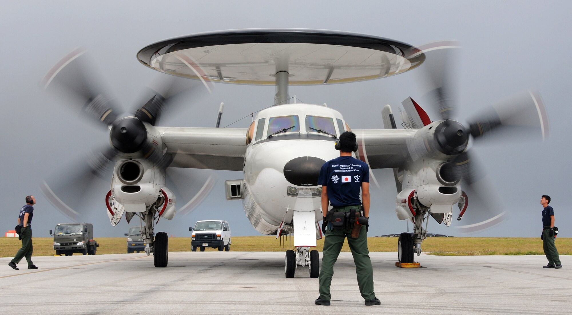 ANDERSEN AIR FORCE BASE, Guam - Japan Air Self Defense Force air crew members direct  and watch as the  pilots extend the wings on a E-2C Hawkeye here after returning from an exercise during Cope North Feb. 5. The large 24ft diameter circular antenna radome above the rear fuselage is a radar system that is capable of tracking more than 2,000 targets and controlling the interception of 40 hostile targets. One radar sweep covers six million cubic miles. The radar's total radiation aperture control antenna reduces sidelobes and is robust against electronic countermeasures. It is capable of detecting aircraft at ranges greater than 550km. The E-2Cs are deployed to Guam  from the 601st Squadron, Misawa Air Base. (U.S. Air Force photo by Airman 1st Class Courtney Witt)(released)



