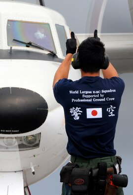 ANDERSEN AIR FORCE BASE, Guam - Japan Air Self Defense Force Crew Chief gives a thumbs up to a JASDF E-2C Hawkeye pilot  during an exercise here for Cope North Feb 5. The primary role of the E-2C Hawkeye aircraft is an all-weather airborne early-warning aircraft. From an operating altitude above 25,000ft, the Hawkeye warns of approaching air threats and provides threat identification and positional data to fighter aircraft. Secondary roles include strike command and control, surveillance, guidance of search and rescue missions and as a relay to extend the range of communications. The E-2Cs are deployed to Guam  from the 601st Squadron, Misawa Air Base. (U.S. Air Force photo by Airman 1st Class Courtney Witt)(released)