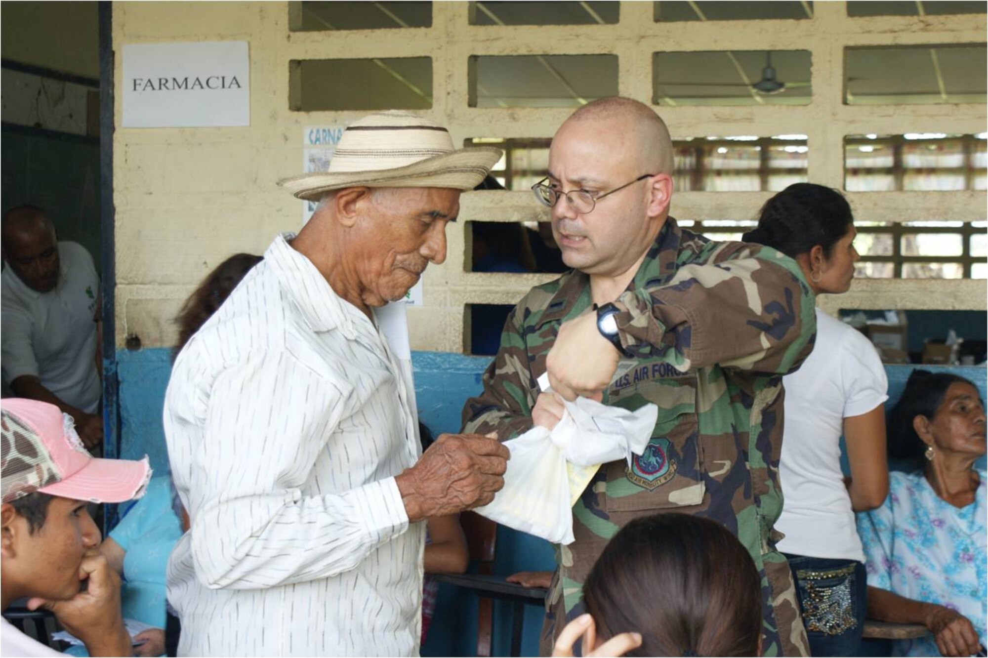 Lt. Primitivo Pena, an ER nurse with the 452nd Aerospace Medicine Squadron,  explains a patient’s prescription. Medications were distributed with directions in the patient’s language.(U.S. Air Force photo)