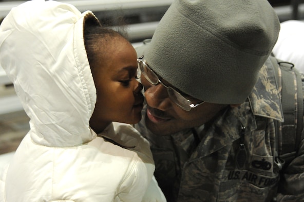 Staff Sgt. Andre Patrick greets his daughter during the Operation Homecoming ceremony Eglin Air Force Base's King Hangar  Feb. 4. Sergeant Patrick and 150 other Hurlburt Airmen returned home from deployments to the Middle East. (U.S. Air Force photo/Senior Airman Stephanie Jacobs)