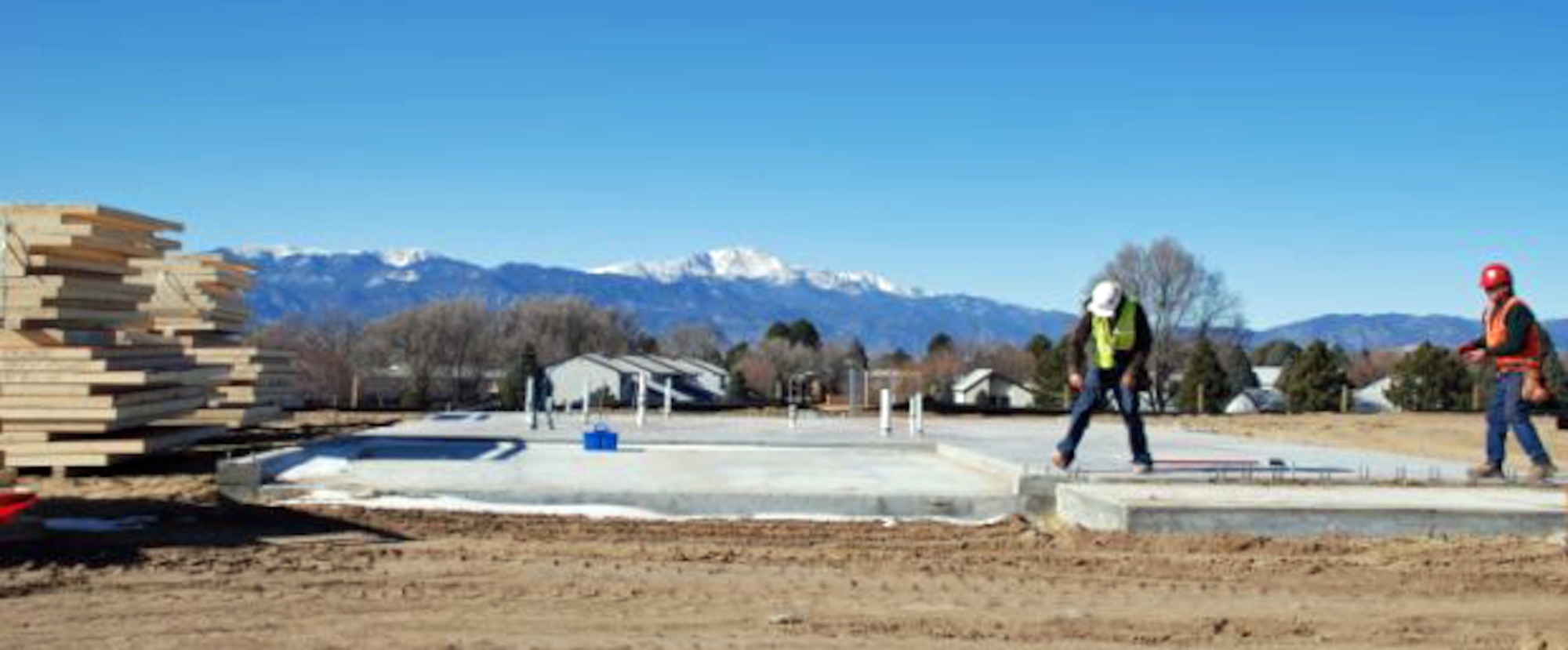 Construction workers work on new Peterson AFB housing.