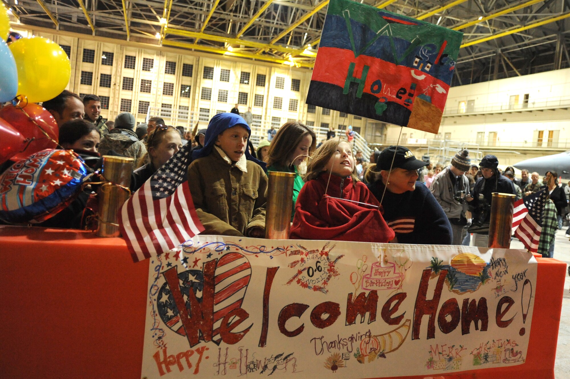 Family members and friends anxiously wait to welcome home Lt. Col. Jim Bitzes during the Operation Homecoming ceremony at Eglin Air Force Base's King Hangar Feb. 4. Colonel Bitzes and 150 other Hurlburt Airmen returned home from deployments to the Middle East. (U.S. Air Force photo/Senior Airman Stephanie Jacobs)