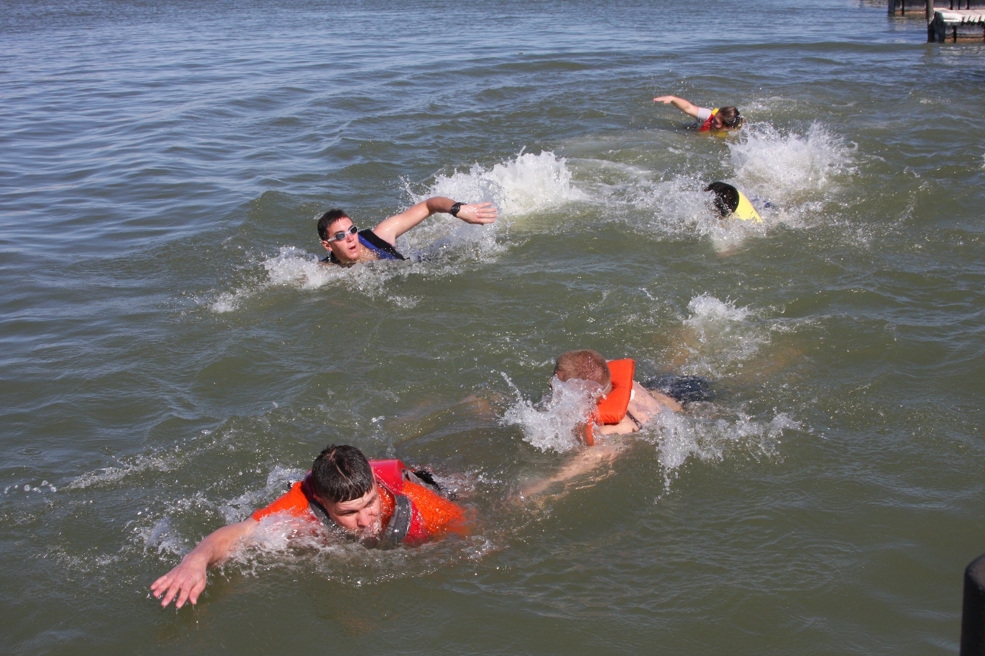 Airmen from Goodfellow Air Force Base swim for shore during the annual Polar Bear Swim Jan. 31 at the Goodfellow Recreation Camp at Lake Nasworthy. The 316th Training Squadron won the trophy for having the most members of their unit jump in the water at the event, which tests the endurance of our battle-ready Airmen, Soldiers, Sailors and Marines. (U.S. Air Force photo by Julie Manuel)