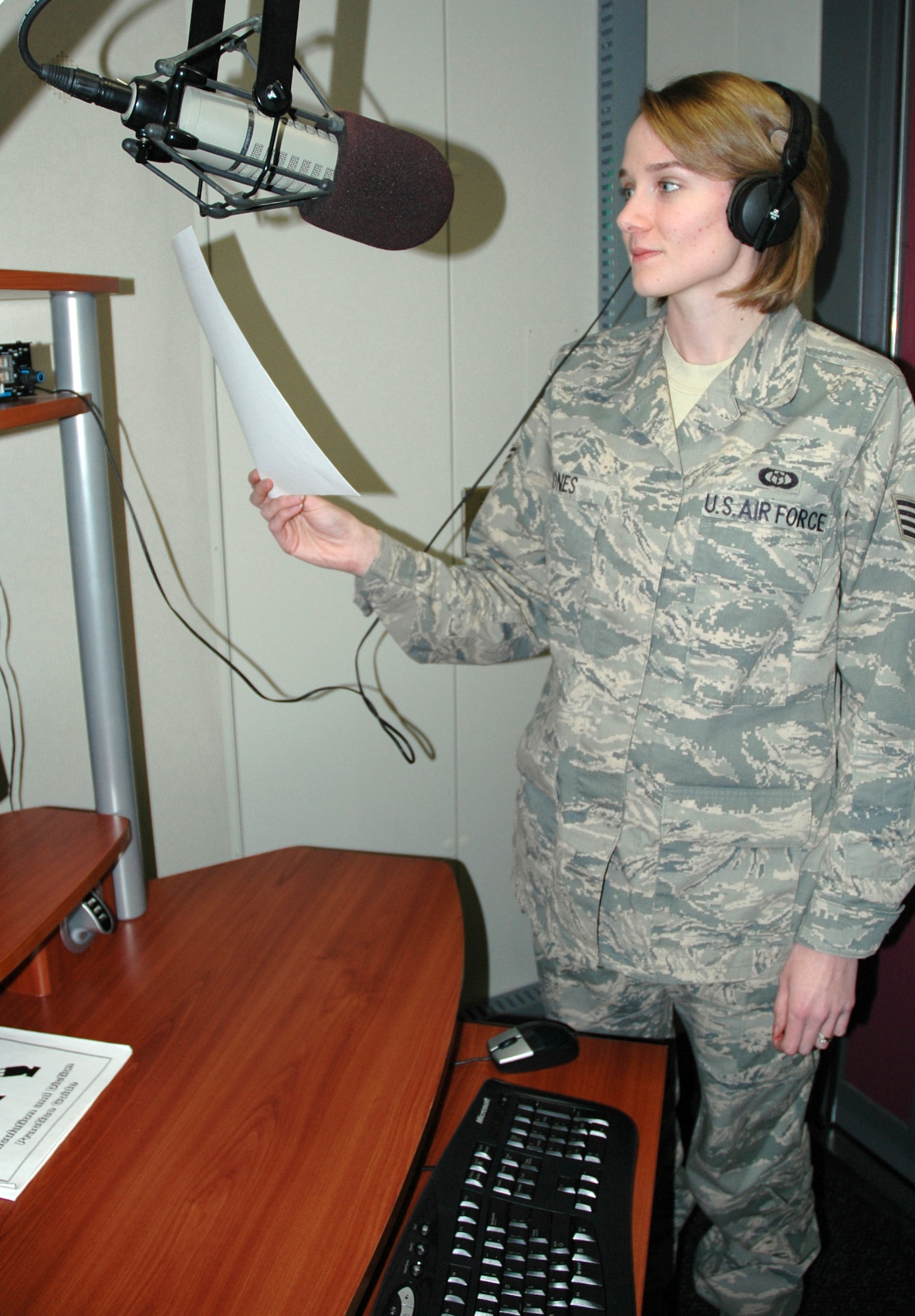 Staff Sgt. Rebecca Jones, a broadcast weather technician with the American Forces Network Weather Center at Offutt Air Force Base, Neb., reads a script for an upcoming AFNWC broadcast. (U.S. Air Force photo/Ryan Hansen)

