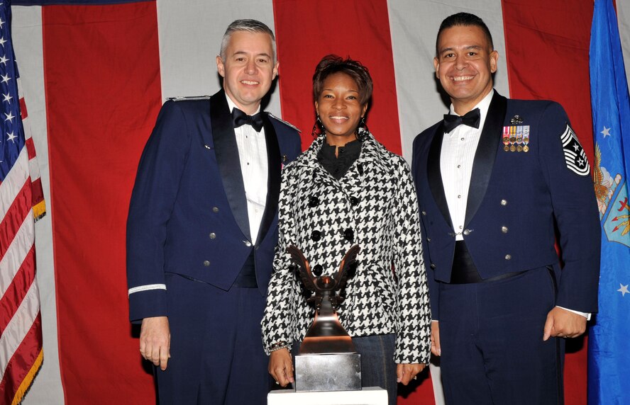 MOODY AIR FORCE BASE, Ga. -- Sheena Echols, wife of Senior Airman Quintin Echols, poses for a photo with (left) Col. Kenneth Todorov, 23rd Wing commander and (right) Chief Master Sgt. Paul Burgess, 23rd Wing command chief, during the 2008 Annual Awards Ceremony held at the James H. Rainwater Conference Center in Valdosta, Ga., Jan. 31. Airman Echols is the 23rd Wing 2008 Airman of the Year Award winner. He is currently deployed and was unable to attend the ceremony. (U.S. Air Force photo by Senior Airman Schelli Jones)