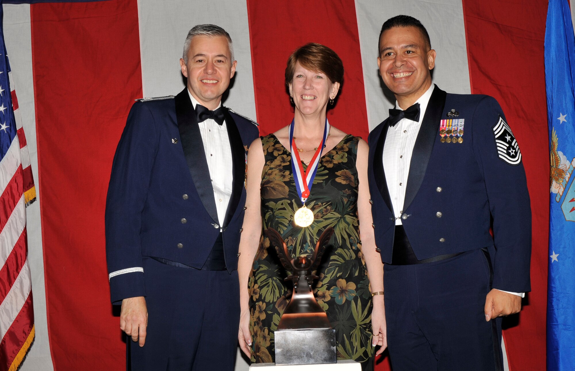 MOODY AIR FORCE BASE, Ga. -- Kim Pfender, 23rd Wing 2008 Civilian of the Year Non-Appropriated Funds Supervisor Award winner, poses for a photo with (left) Col. Kenneth Todorov, 23rd Wing commander and (right) Chief Master Sgt. Paul Burgess, 23rd Wing command chief, during the 2008 Annual Awards Ceremony held at the James H. Rainwater Conference Center Jan. 31. (U.S. Air Force photo by Senior Airman Schelli Jones) 