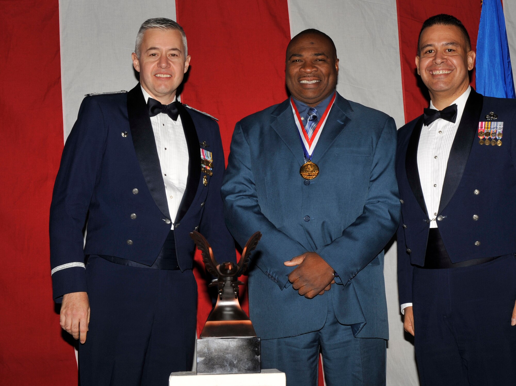MOODY AIR FORCE BASE, Ga. -- Perry Tillman, 23rd Wing 2008 Civilian of the Year Professional and Analytical Award winner, poses for a photo with (left) Col. Kenneth Todorov, 23rd Wing commander and (right) Chief Master Sgt. Paul Burgess, 23rd Wing command chief, during the 2008 Annual Awards Ceremony held at the James H. Rainwater Conference Center Jan. 31. (U.S. Air Force photo by Senior Airman Schelli Jones)
