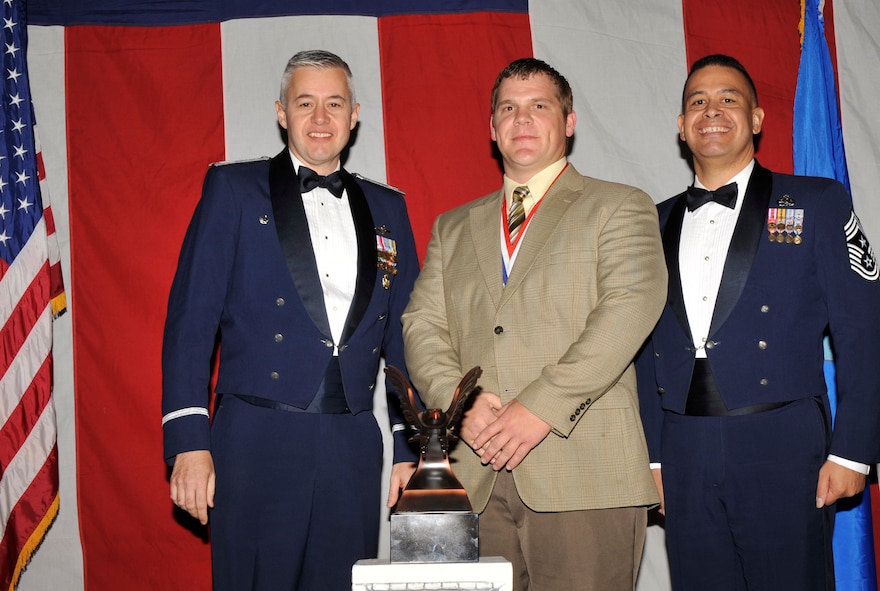 MOODY AIR FORCE BASE, Ga. -- Kevin Moore, 23rd Wing 2008 Civilian of the Year Technical, Clerical and Other Award winner, poses for a photo with (left) Col. Kenneth Todorov, 23rd Wing commander and (right) Chief Master Sgt. Paul Burgess, 23rd Wing command chief, during the 2008 Annual Awards Ceremony held at the James H. Rainwater Conference Center Jan. 31. (U.S. Air Force photo by Senior Airman Schelli Jones)