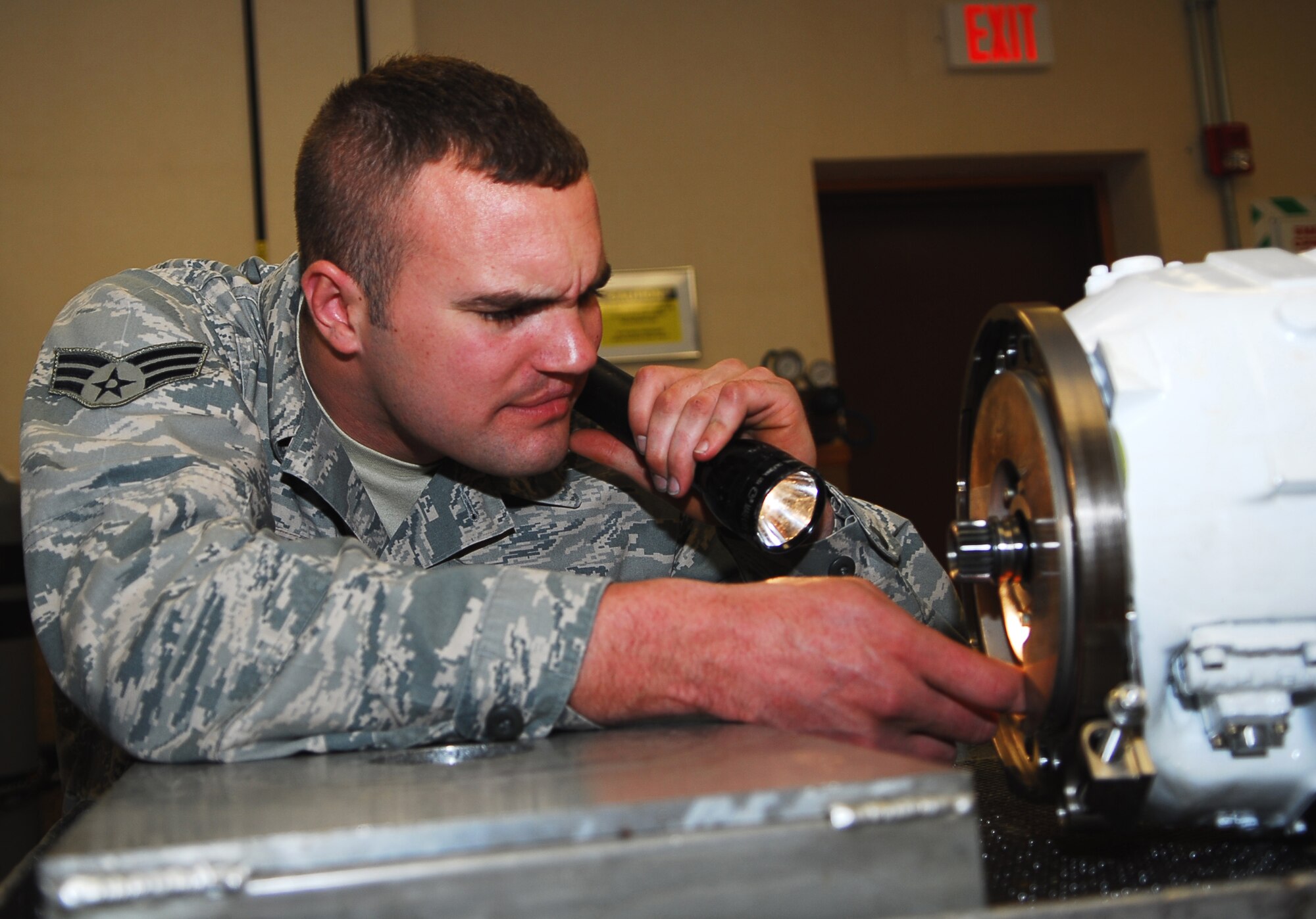 Senior Airman Ryan Camplain, 56th Component Maintenance Squadron electrical and environmental systems journeyman, inspects a constant speed drive Jan. 29 at the E and E back shop. The constant speed drive keeps the F-16’s main and standby generators turning at a constant speed. (Air Force photo by Staff Sgt. Phillip Butterfield) 