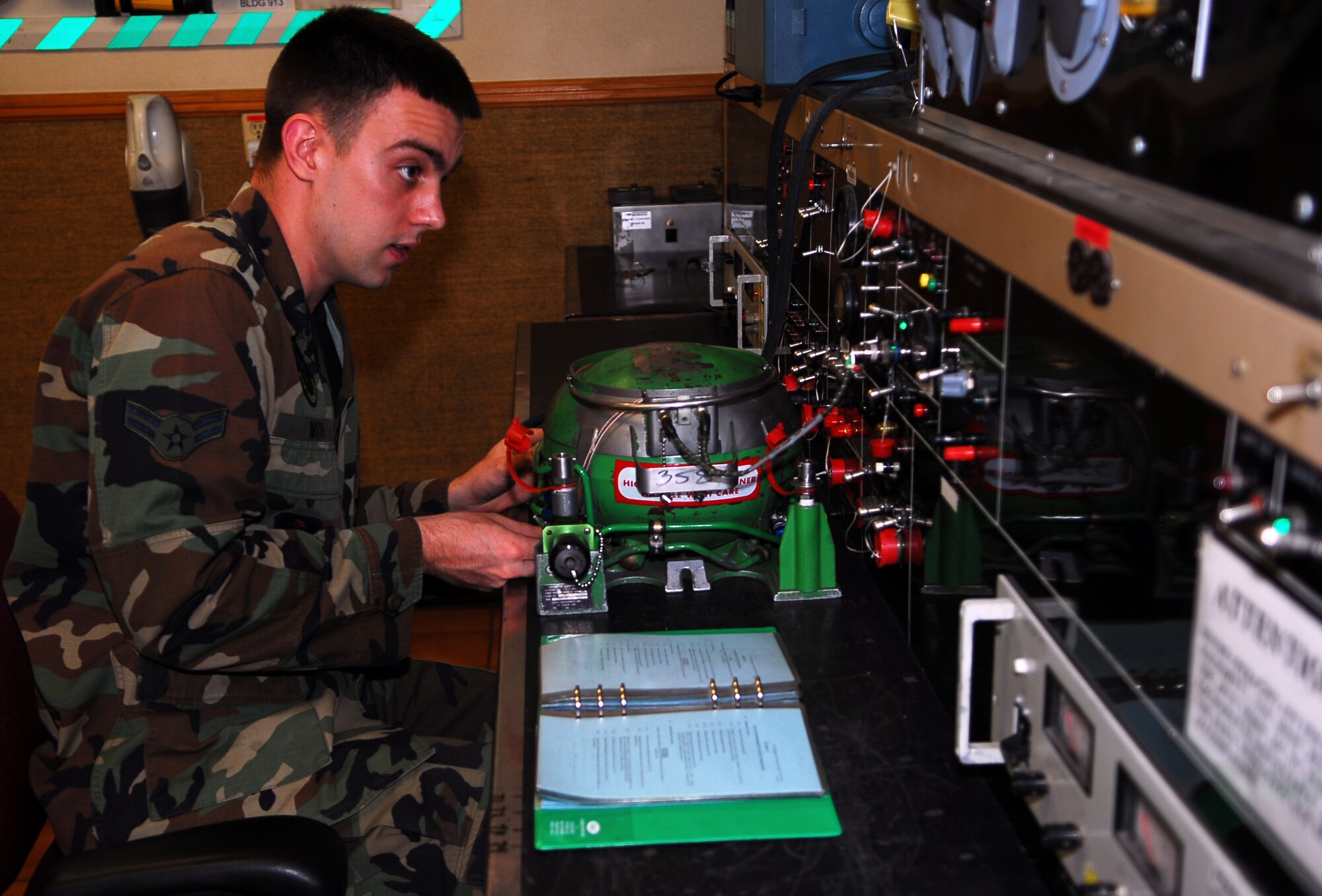 Airman 1st Class Davis Mayo, 56th Component Maintenance Squadron electrical and environmental systems journeyman, tests a liquid oxygen converter on a test bench Jan. 29 at the E and E back shop. The LOX converter supplies the pilot with pure oxygen during flight. (Air Force photo by Staff Sgt. Phillip Butterfield) 