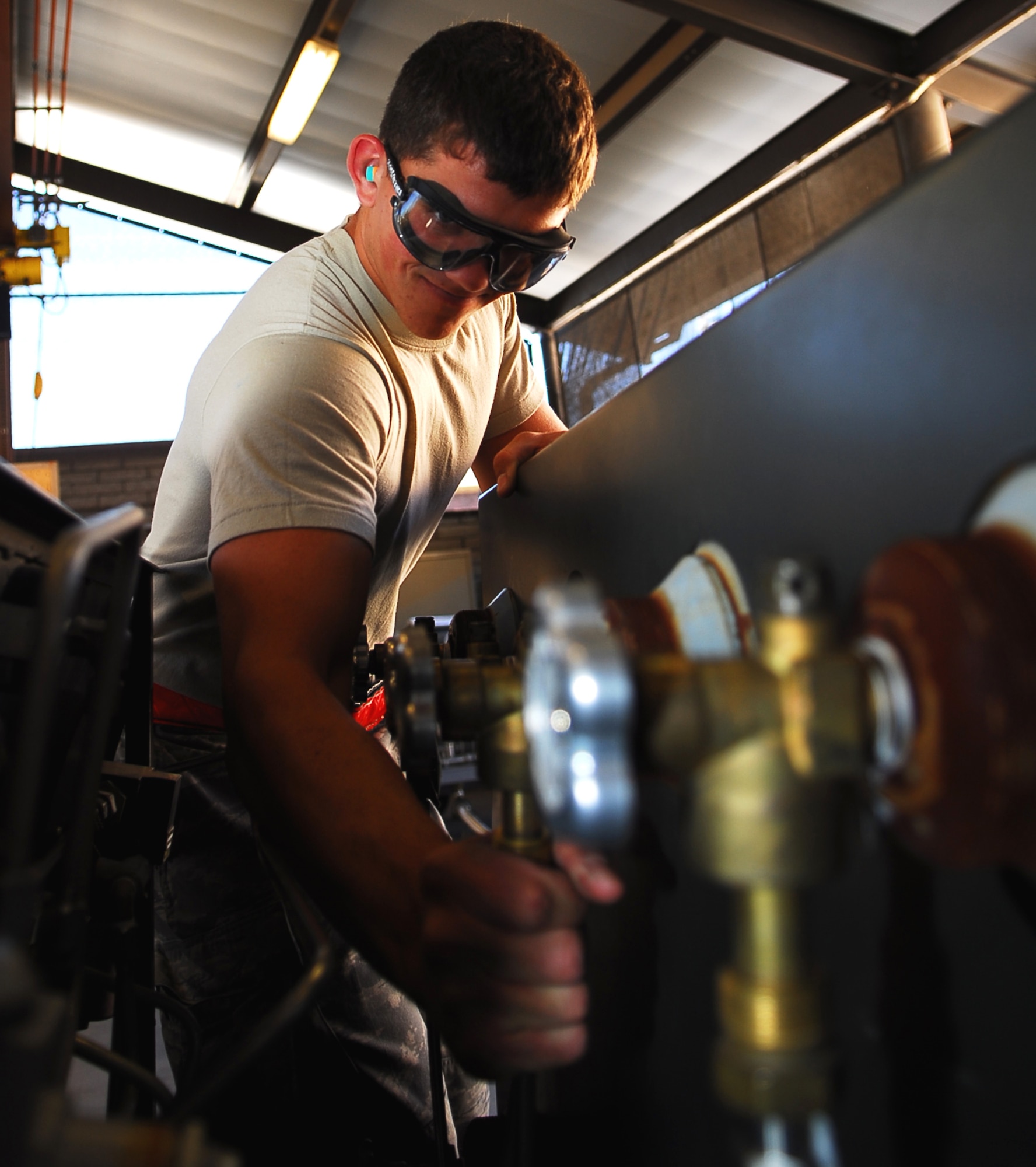 Senior Airman Sean Bowley, 56th Component Maintenance Squadron electrical and environmental systems journeyman, repositions an airline on an eight bottle nitrogen cart Jan. 29 at the E and E back shop.  Nitrogen gas is used to inflate aircraft tires because it’s non-flammable. (Air Force photo by Staff Sgt. Phillip Butterfield) 