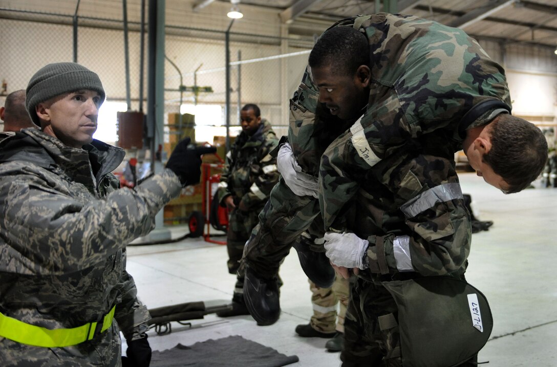LANGLEY AIR FORCE BASE, Va. -- Airmen from the 1st Civil Engineer Squadron practice the firemen's carry during self aid buddy care training as part of an Ability to Survive and Operate Rodeo here Feb. 4. The rodeo provided training to more than 700 Airmen to prepare them for deployment.  (U.S. Air Force photo/Airman Rebecca Montez)