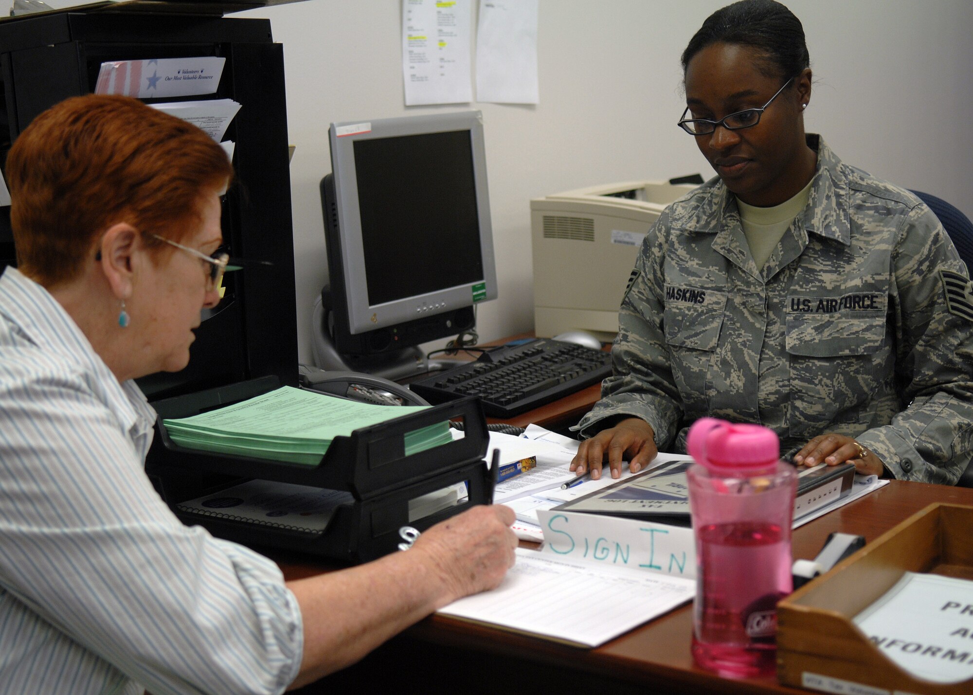 Tech. Sgt. Tynisa Haskins, 49th Fighter Wing Tax Center manager, assists a customer with signing into the Tax Center located in building 29 at Holloman Air Force Base, N.M., Feb. 4. The Tax Center is open to all active duty military members, dependents and retirees. (U.S. Air Force photo/Staff Sgt. Anthony Nelson Jr.)
