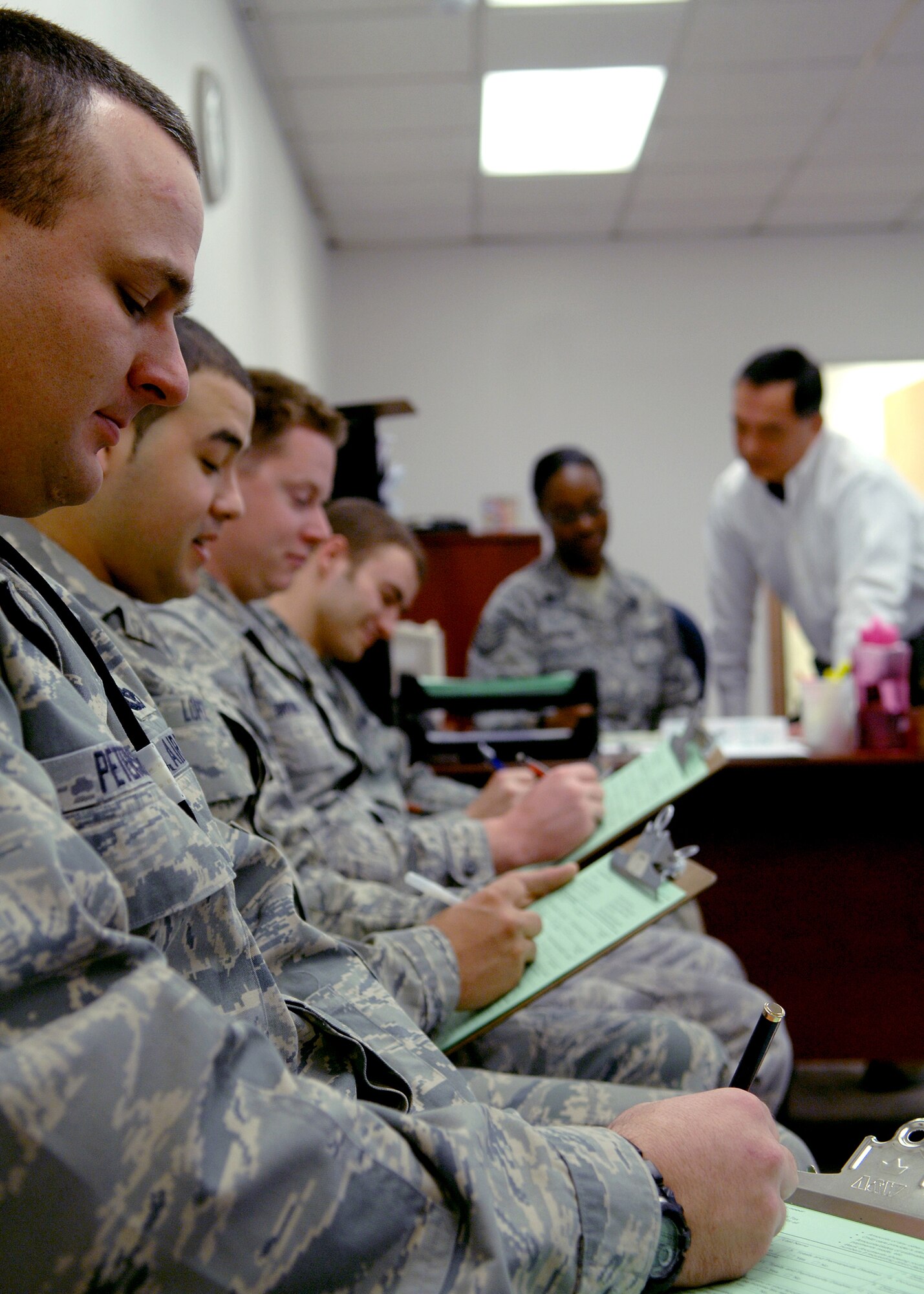 Tech. Sgt. Benjamin Peterson, 49th Materiel Maintenance Group, Senior Airman Matthew Lopez, 49th Aircraft Maintenance Squadron, Airman 1st Class Lawrence Broome, 49th Logistics Readiness Squadron and Airman 1st Class Brad Biesinger, also 49 LRS, all receive assistance from the Tax Center located in building 29 at Holloman Air Force Base, N.M., Feb. 4. The Tax Center offers services to all active duty military members, dependents and retirees free of charge. (U.S. Air Force photo/Staff Sgt. Anthony Nelson Jr.)