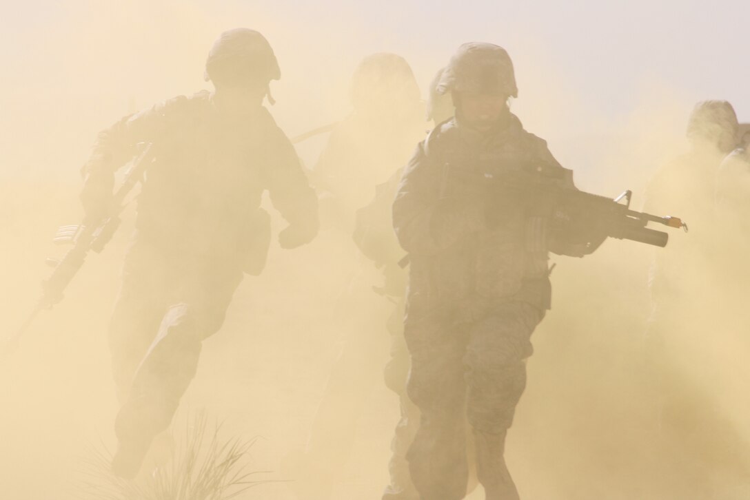 Airmen from the 376th Expeditionary Security Forces Squadron charge toward their objective during a training exercise at McGregor Range, N.M. Photo by Maj. Deanna Bague, Fort Bliss Public Affairs Office