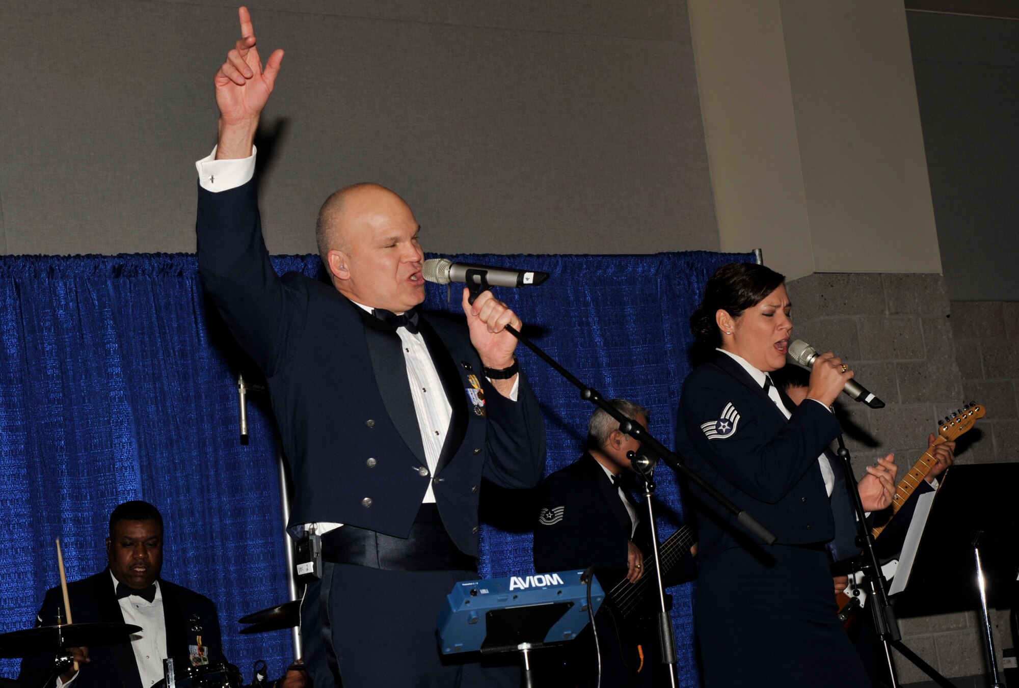 MOODY AIR FORCE BASE, Ga. -- Staff Sgt. Darran Keenom and Staff Sgt. Frances Kness, vocalists for the Band of the U.S. Air Force Reserve’s, “Reserve Generation” perform during the Annual Awards Ceremony  held Jan 31 here. Band members are professional Air Force musicians who perform at concerts held at high schools, colleges and universities in cities throughout the United States. (U.S. Air Force photo by Senior Airman Schelli Jones)