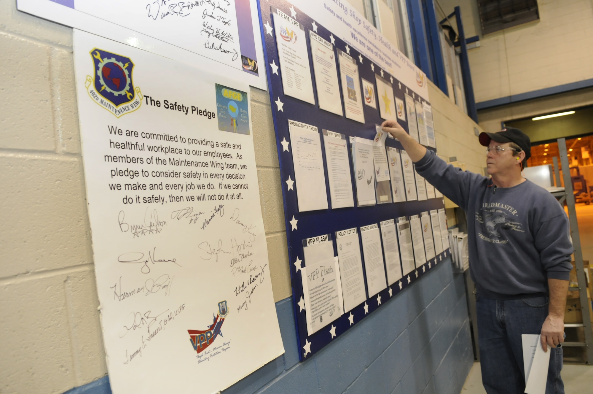 Richard Francis, plating shop team lead for VPP, checks some of the information on the CMXC Plating Shop Safety, Health and VPP board. Employees in the shop can access the board to stay informed on updates or changes. U. S. Air Force photo by Sue Sapp