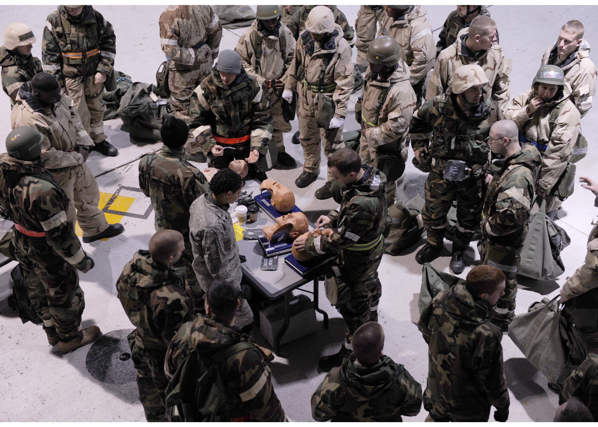 LANGLEY AIR FORCE BASE, Va. -- Airmen watch self aid and buddy care instructors administer a breathing apparatus to a mannequin during an Ability to Survive and Operate Rodeo Feb. 4. The Rodeo provided training to more than 700 Airmen to prepare them for deployment.  (U.S. Air Force photo / Airman 1st Class Jonathan Koob)