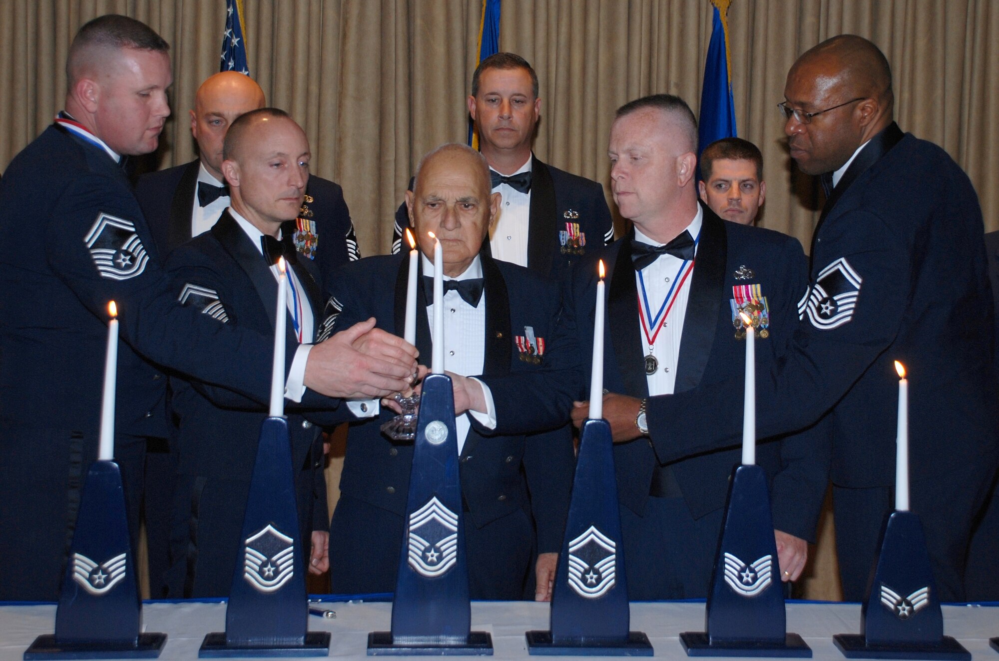 Chief Master Sgt. (ret.) Joseph Pannitto (center) and (left to right) Senior Master Sgts. Jason Pillow, Michael Chambers, Raymond Lagasse and Anthony Johnson light the ceremonial Chief Master Sergeant's candle recognizing their selection for promotion at The Tides Jan. 30. (U.S. Air Force photo by Master Sgt. Bryan Ripple, 920th Rescue Wing)