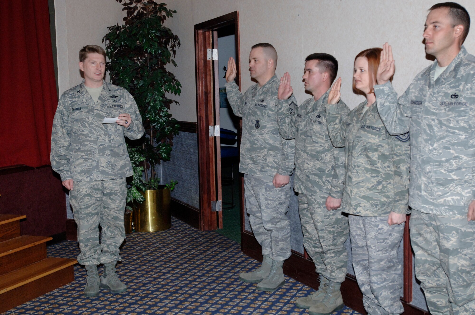 Col. Robert Thomas, 92nd Air Refueling Wing commander, presents Chief Master Sgt. William Stamper 92nd, Maintenance Group Superintendant, with the Team Fairchild Spirit Award during a promotion ceremony at Club Fairchild Jan. 30. The squadron that cheers the loudest for their newly promoted airman wins the award. (U.S. Air Force photo / Tech. Sgt. Larry Carpenter) 