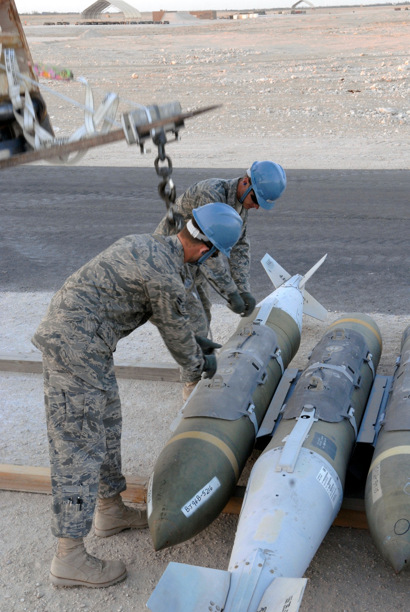 Airman 1st Class Brian Foster and Airman Bryan Newcomer move guided bomb unit-31s during the annual munitions serviceability inspection Feb. 3 at an air base in Southwest Asia. Airman Foster is a 379th Expeditionary Maintenance Squadron ammunitions systems journeymen from Ellijay, Ga., and Airman Newcomer is a 379th EMXS ammunitions systems apprentice and hails from Suwanee, Ga. Both are deployed from Dyess Air Force Base, Texas. (U.S. Air Force photo/Airman 1st Class Andrew Satran) 

