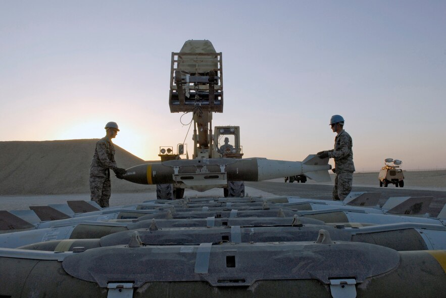 Airman 1st Class Brian Foster (from left to right), Senior Airman Brandon Mullennix and Airman Bryan Newcomer move guided bomb unit-31s during an annual munitions serviceability inspection Feb. 3 at an air base in Southwest Asia. Airmen Foster and Bullennix are 379th Expeditionary Maintenance Squadron ammunitions systems journeymen. All are deployed from Dyess Air Force Base, Texas. Airman Mullennix is from Angleton, Texas. Airman Foster is from Ellijay, Ga., Airman Newcomer is a 379th EMXS ammunitions systems apprentice and hails from Suwanee, Ga. (U.S. Air Force photo/Airman 1st Class Andrew Satran) 
