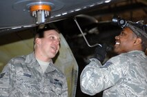 MINOT AIR FORCE BASE, N.D. --  Staff Sgt. Cameron Sogge, weapons load team chief, observes weapons load crew member Staff Sgt Deonta Griffin, both from the 5th Aircraft Maintenance Squadron, as Sergeant Griffin uses a speed handle to install an environmental control system during a load crew competition here Feb. 3. (U.S. Air Force photo by Senior Airman Kelly Timney)