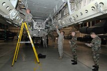 MINOT AIR FORCE BASE, N.D. --  A team of weapons loaders from the 5th Aircraft Maintenance Squadron here, load weapons onto a B-52H Stratofortress during an Eighth Air Force inspected load crew competition here Feb. 3. (U.S. Air Force photo by Senior Airman Kelly Timney)