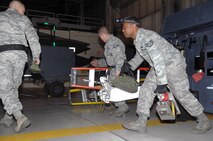 MINOT AIR FORCE BASE, N.D. --  Staff Sgt Deonta Griffin, 5th Aircraft Maintenance Squadron weapons load crew member, and his team show a sense of urgency as they begin the task of loading weapons onto a B-52H Stratofortress during an Eighth Air Force inspected load crew competition, here Feb. 3. (U.S. Air Force photo by Senior Airman Kelly Timney)