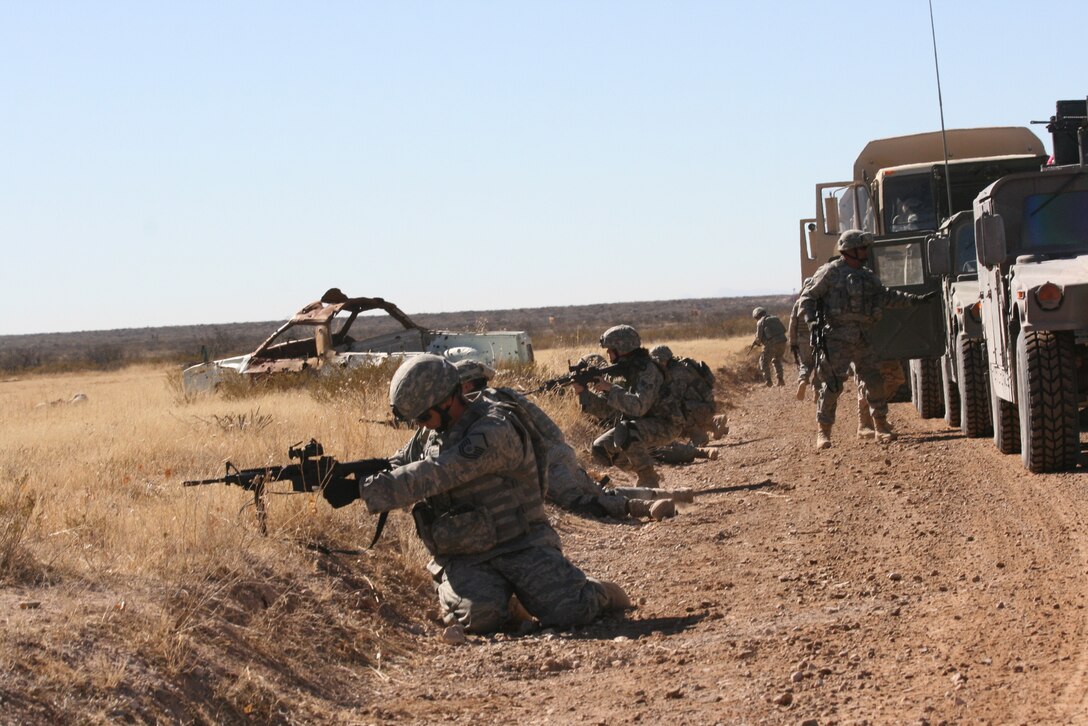 Airmen from the 376th Expeditionary Security Forces Squadron, dismount and take the prone position during a convoy live fire exercise at McGregor Range, N.M.  Photo by Maj. Deanna Bague, Fort Bliss Public Affairs Office
