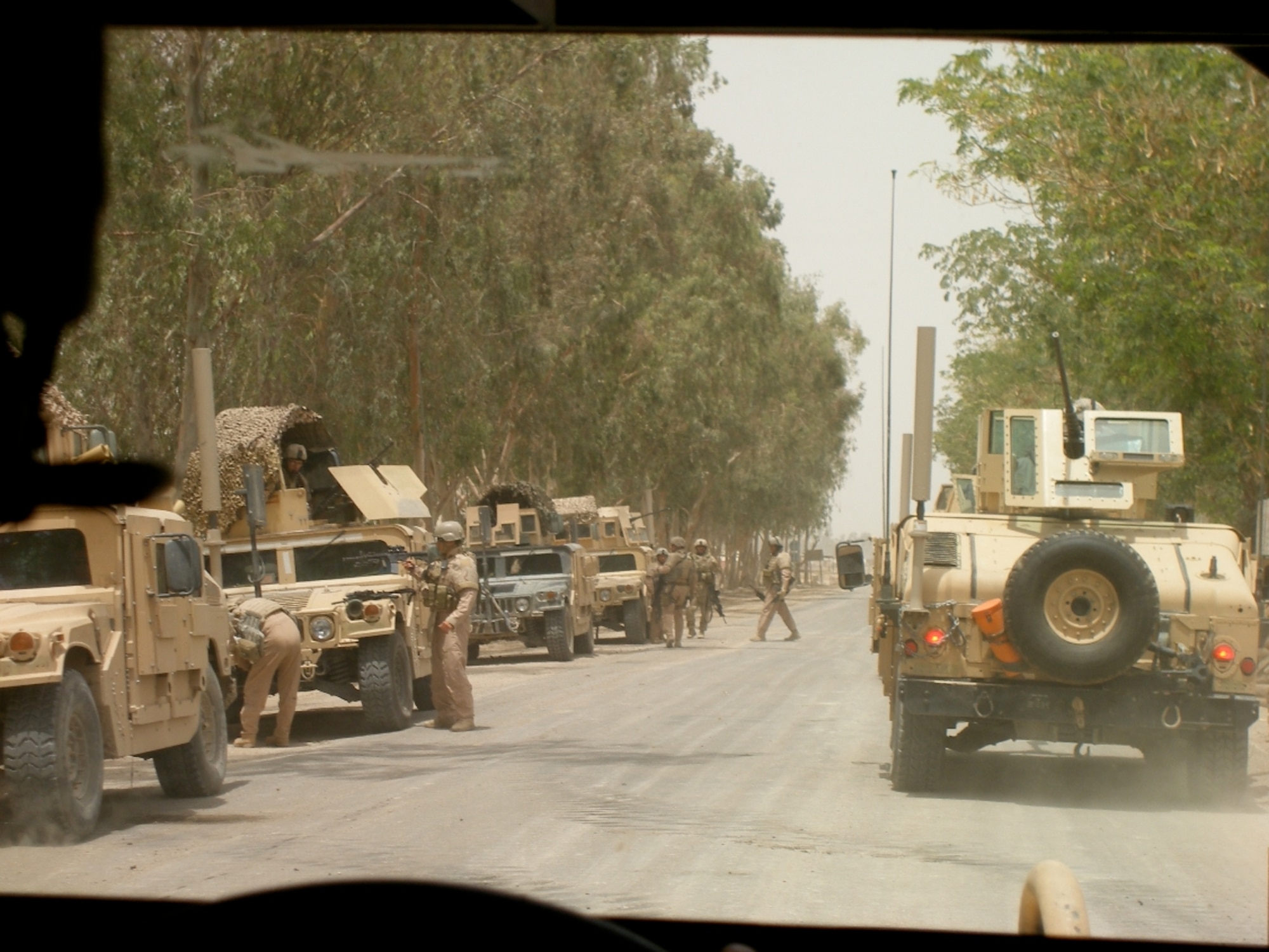 A line-up of military vehicles, several of which have CREW systems attached to jam radio signals and prevent the detonation of RCIEDs. Photo courtesy of Master Sgt. Steven Sutton.