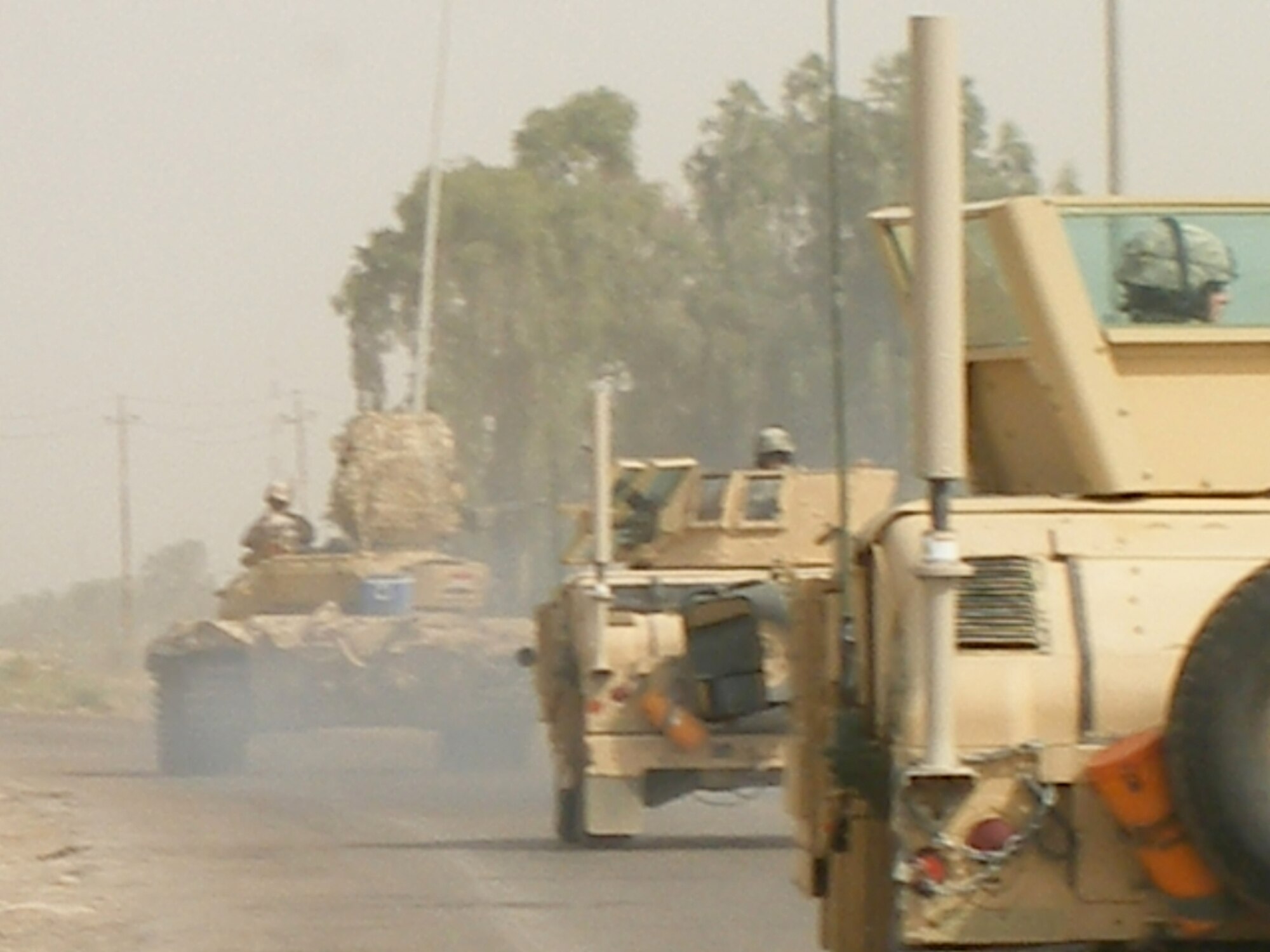 The large antennas that are part of the CREW system are easy to spot on the Army vehicles in convoy. Photo courtesy of Master Sgt. Steven Sutton.