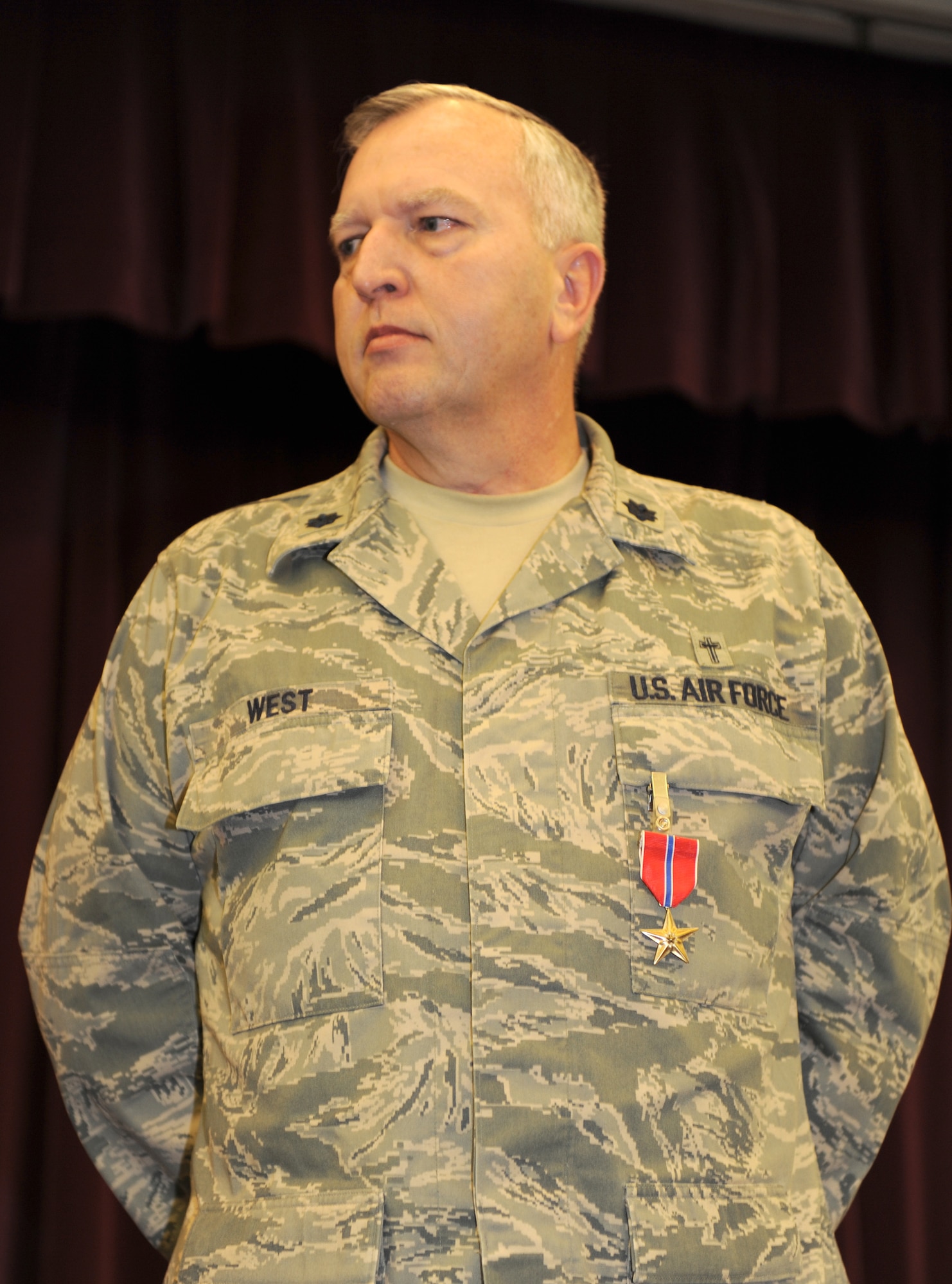 WHITEMAN AIR FORCE BASE, Mo. – Chaplain (Col.) Steven West, 509th Bomb Wing chaplain, proudly displays the Bronze Star he received from Brig. Gen. Garrett Harencak, 509th Bomb Wing commander, Jan. 28 during the National Prayer Breakfast. (U.S. Air Force photo/Airman 1st Class Carlin Leslie)