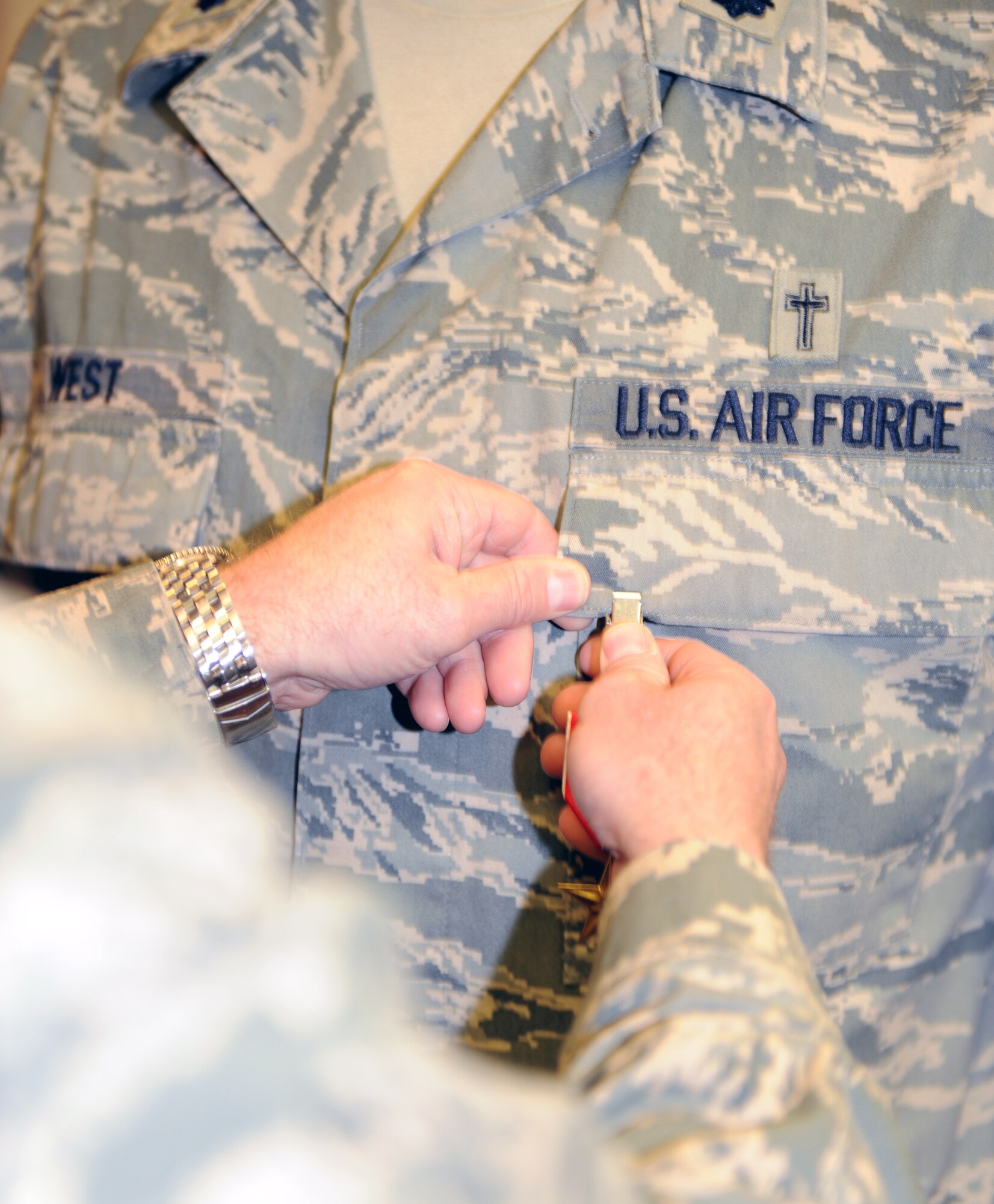WHITEMAN AIR FORCE BASE, Mo. Brig. Gen. Garrett Harencak, 509th Bomb Wing commander, pins the Bronze Star on Chaplain (Col.) Steven West, 509th Bomb Wing chaplain, Jan. 28 during the National Prayer Breakfast at the Mission’s End. Chaplain West received his Bronze Star for meritorious service during his deployment in Iraq. (U.S. Air Force photo/Airman 1st Class Carlin Leslie)