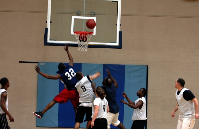 Terry Frazier, Zachariah Spaulding and Dominick Ward jump up to recover a rebound during the season-opener intramural basketball game Feb. 3 at the Fitness and Sports Center. Frazier and Ward are with the 437th Logistics Readiness Squadron and Spaulding is with the 437th Security Forces Squadron. (U.S. Air Force photo/Senior Airman Timothy Taylor)