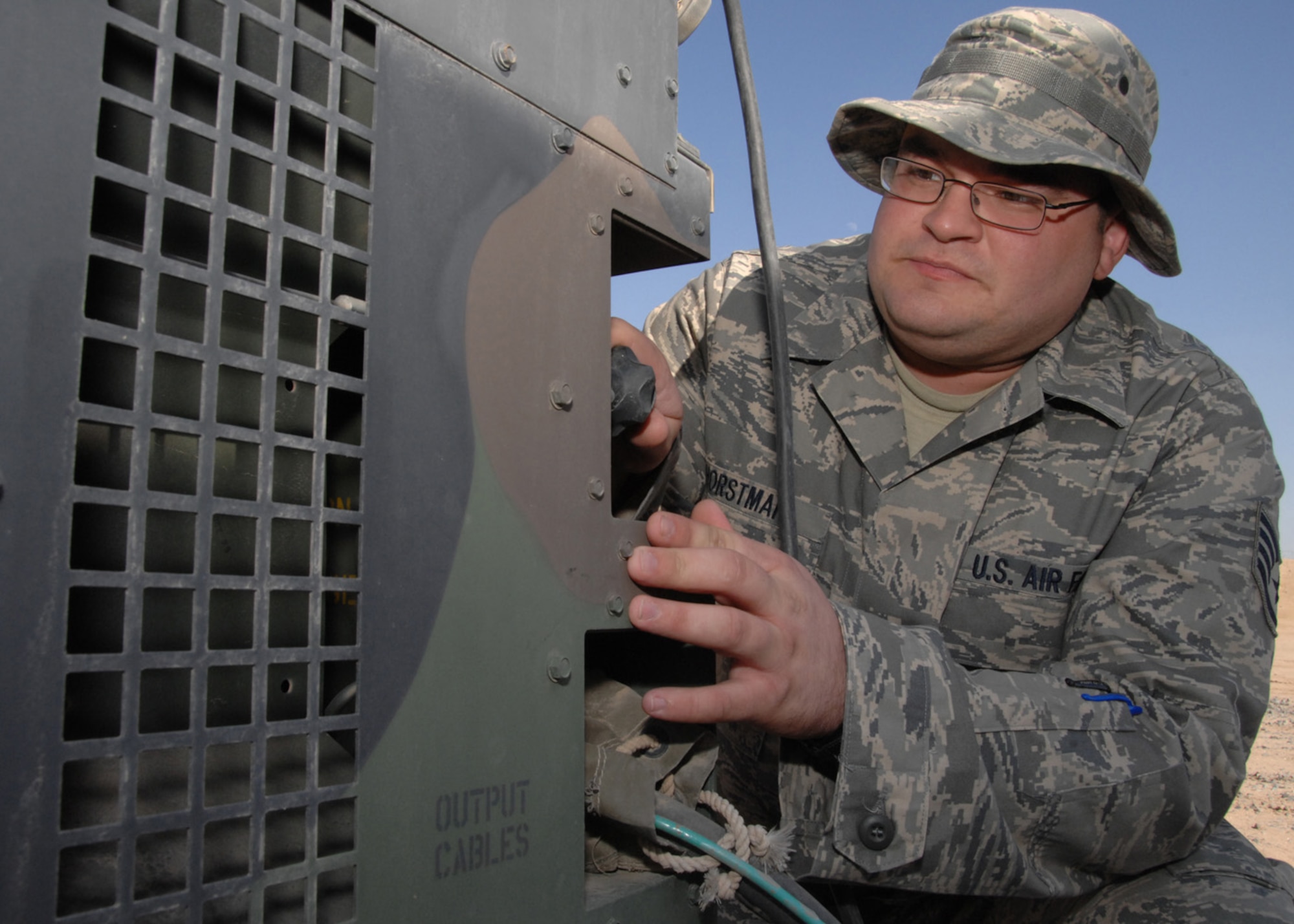 SOUTHWEST ASIA -- Staff Sgt. Wade Horstman, 386th Expeditionary Civil Engineer Squadron, conducts a weekly inspection on a generator connected to an airborne chemical detector at an air base in Southwest Asia, Feb. 4. Sergeant Horstman is the emergency management logistics non-commissioned officer in charge currently deployed from the 114th Fighter Wing at Foss Field, S.D.(U.S. Air Force photo/Senior Airman Courtney Richardson)