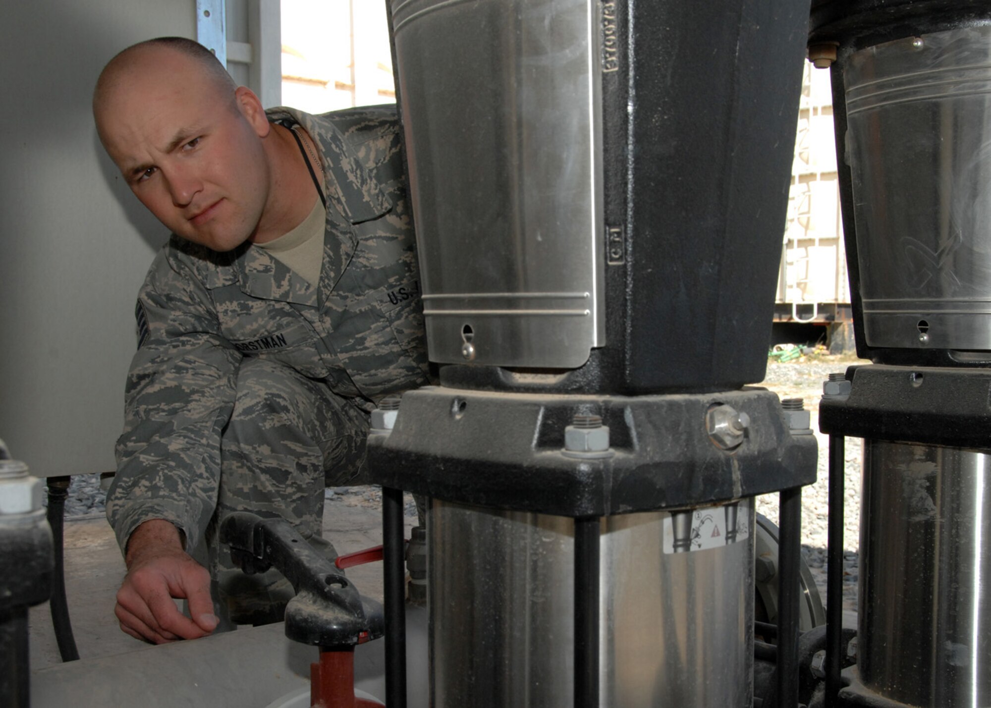 SOUTHWEST ASIA -- Staff Sgt. Josh Horstman, 386th Expeditionary Civil Engineer Squadron, checks the temperature gauge on a water pump system at an air base in Southwest Asia, Feb. 4.  Sergeant Horstman is a plumber currently deployed from the 114th Fighter Wing at Foss Field, S.D. (U.S. Air Force photo/Senior Airman Courtney Richardson)