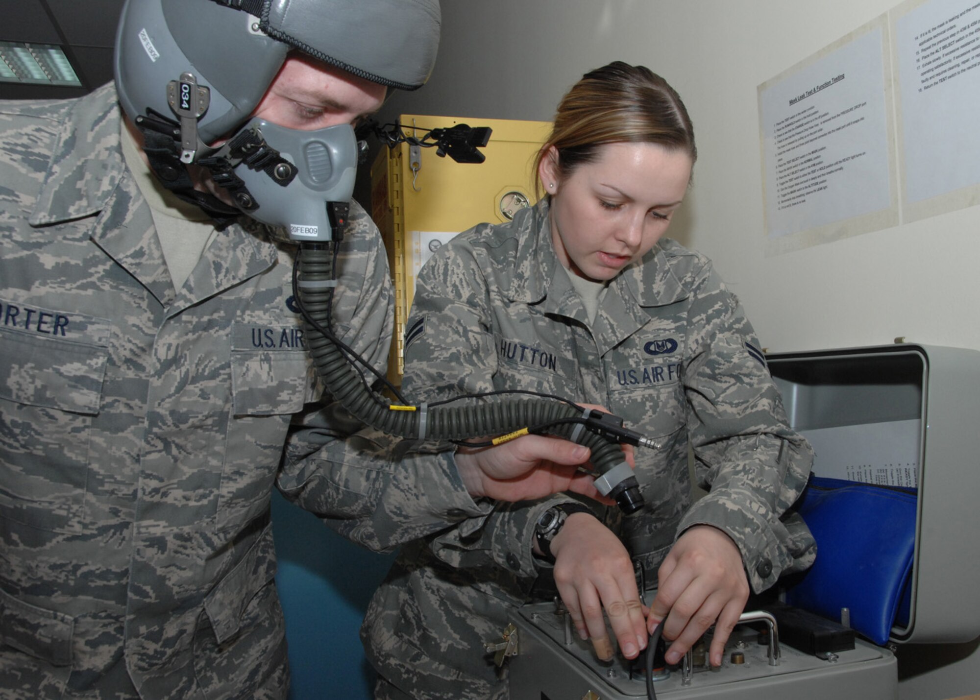 SOUTHWEST ASIA -- Airman 1st Class Kayla Hutton, 43rd Expeditionary Electronic Combat Squadron life support technician, hooks up a helmet to a Scot Communications and Oxygen Tester for inspection at an air base in Southwest Asia, Feb. 3. The tester checks for leaks in their mask and lets them know if the microphone and ear cups are working properly.(U.S. Air Force photo/Senior Airman Courtney Richardson)