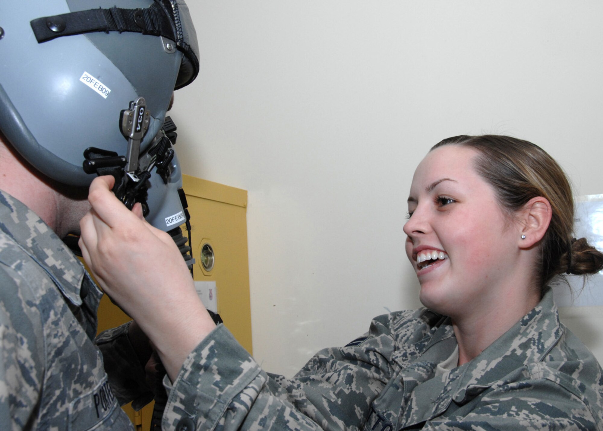 SOUTHWEST ASIA -- Airman 1st Class Kayla Hutton, 43rd Expeditionary Electronic Combat Squadron life support technician, adjust the fit of a helmet before it can be inspected at an air base in Southwest Asia, Feb. 3. All helmets are personally fit for each individual to ensure a proper seal for oxygen to pass through. (U.S. Air Force photo/Senior Airman Courtney Richardson)