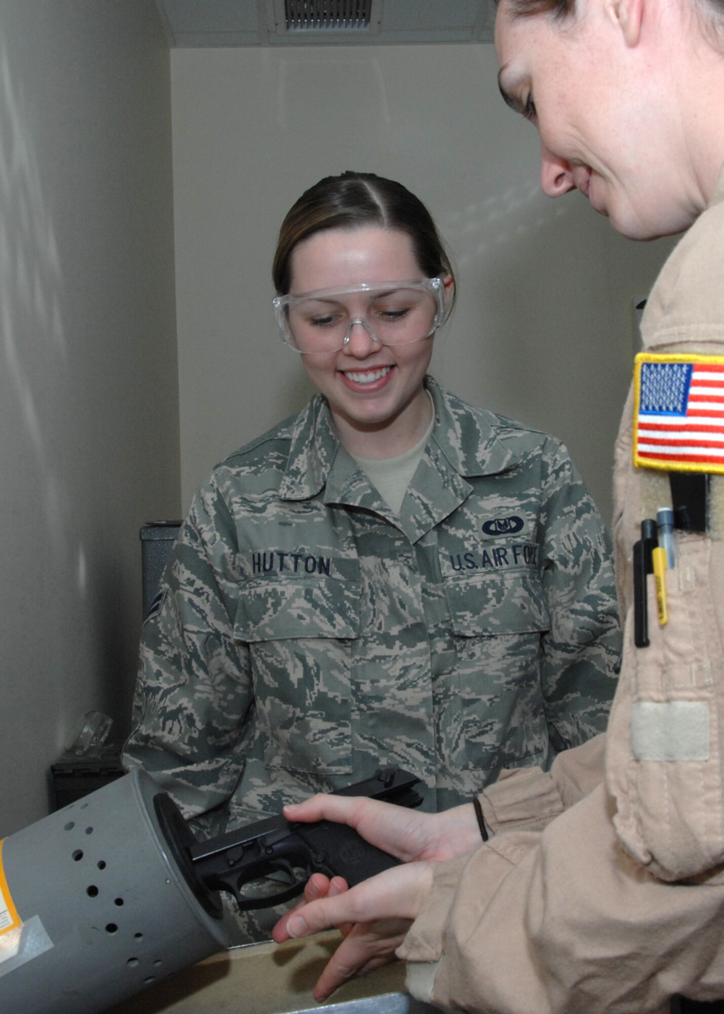 SOUTHWEST ASIA -- Airman 1st Class Kayla Hutton, 43rd Expeditionary Electronic Combat Squadron life support technician, monitors an aircrew member load their weapon at an air base in Southwest Asia, Feb. 3. Airman Hutton is responsible for the issuing of weapons and ammunitions to the aircrew as well as other life saving equipment. (U.S. Air Force photo/Senior Airman Courtney Richardson)