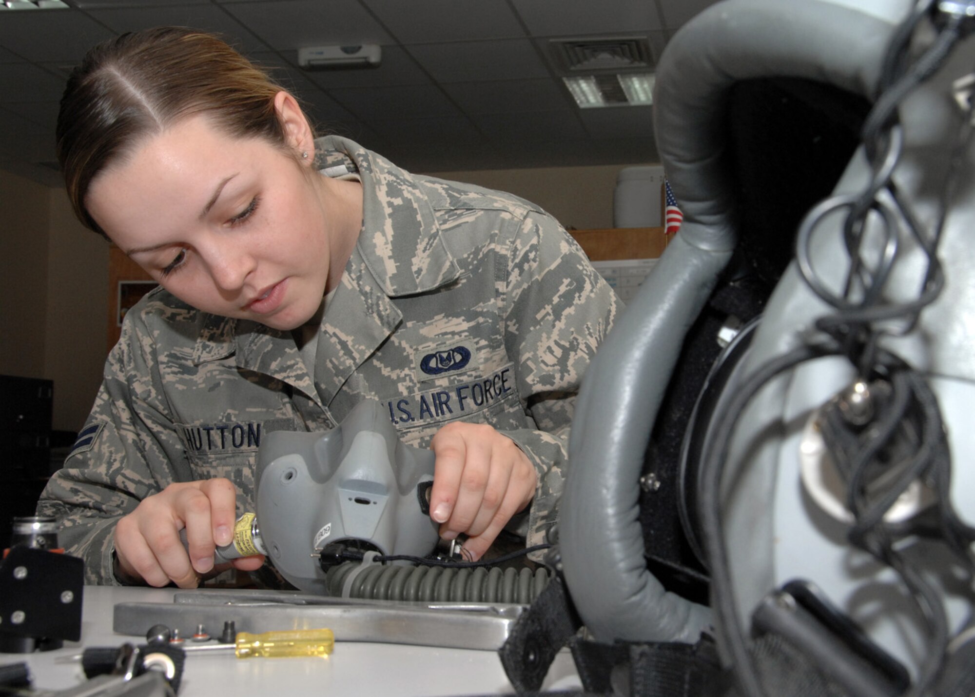 SOUTHWEST ASIA -- Airman 1st Class Kayla Hutton, 43rd Expeditionary Electronic Combat Squadron life support technician, reattaches screws to the inside of a mask at an air base in Southwest Asia, Feb. 3. The screws inside of the mask need to be torque at a certain amount according to technical orders. (U.S. Air Force photo/Senior Airman Courtney Richardson)