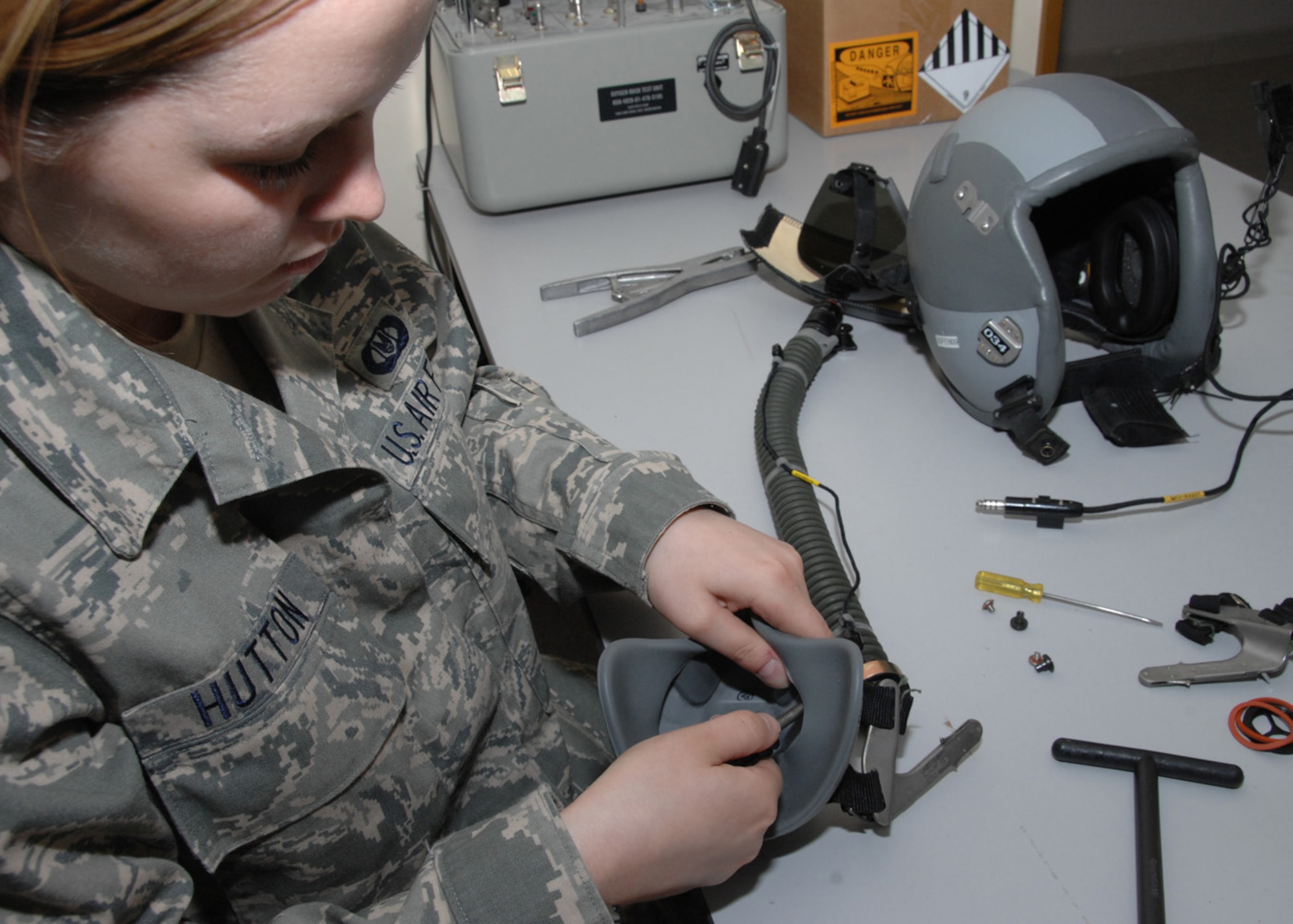 SOUTHWEST ASIA -- Airman 1st Class Kayla Hutton, 43rd Expeditionary Electronic Combat Squadron life support technician, disassembles a mask for inspection at an air base in Southwest Asia, Feb. 3. Each piece of the mask must be inspected to ensure its serviceability. (U.S. Air Force photo/Senior Airman Courtney Richardson)