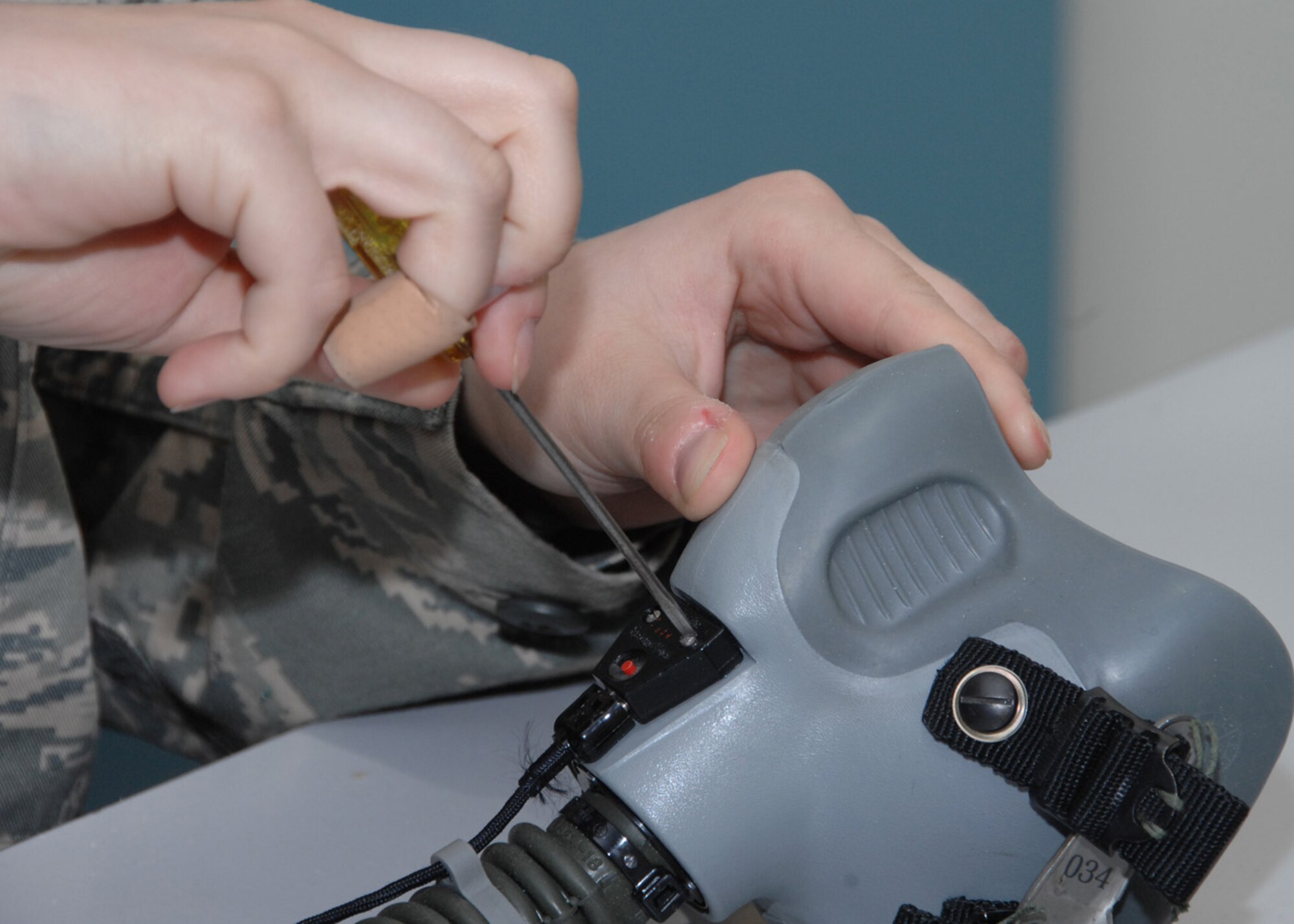 SOUTHWEST ASIA -- Airman 1st Class Kayla Hutton, 43rd Expeditionary Electronic Combat Squadron life support technician, breaks down a helmet mask at an air base in Southwest Asia, Feb. 3. The mask and the helmet get broken down every 90 days to ensure everything works correctly. (U.S. Air Force photo/Senior Airman Courtney Richardson)