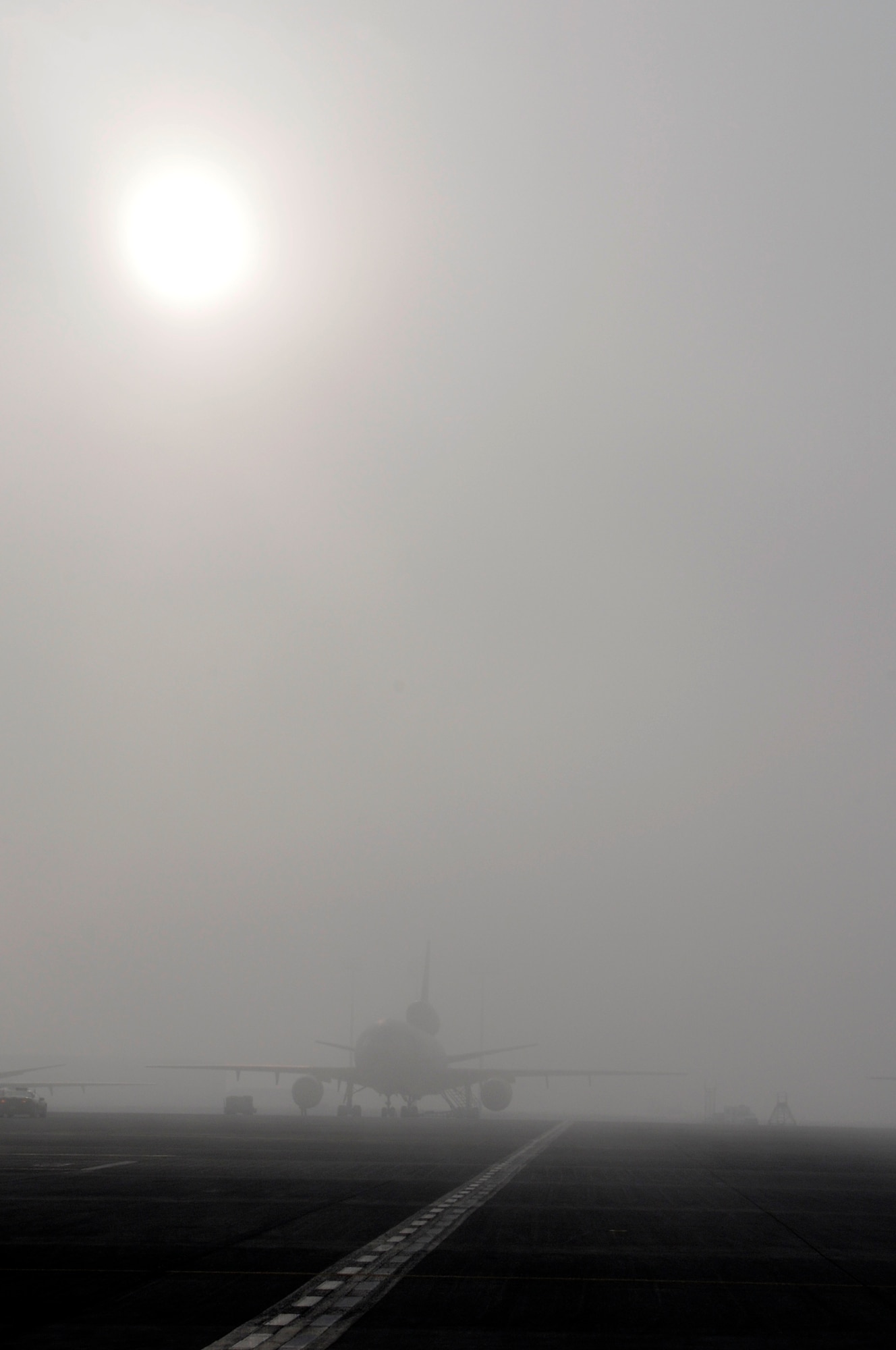 SOUTHWEST ASIA - A KC-10 Extender sits on the flightline at the 380th Air Expeditionary Wing as the sun breaks through on a foggy morning, Jan 28. The 380th AEW always stands mission ready. (U.S. Air Force photo by Senior Airman Brian J. Ellis) (Released)