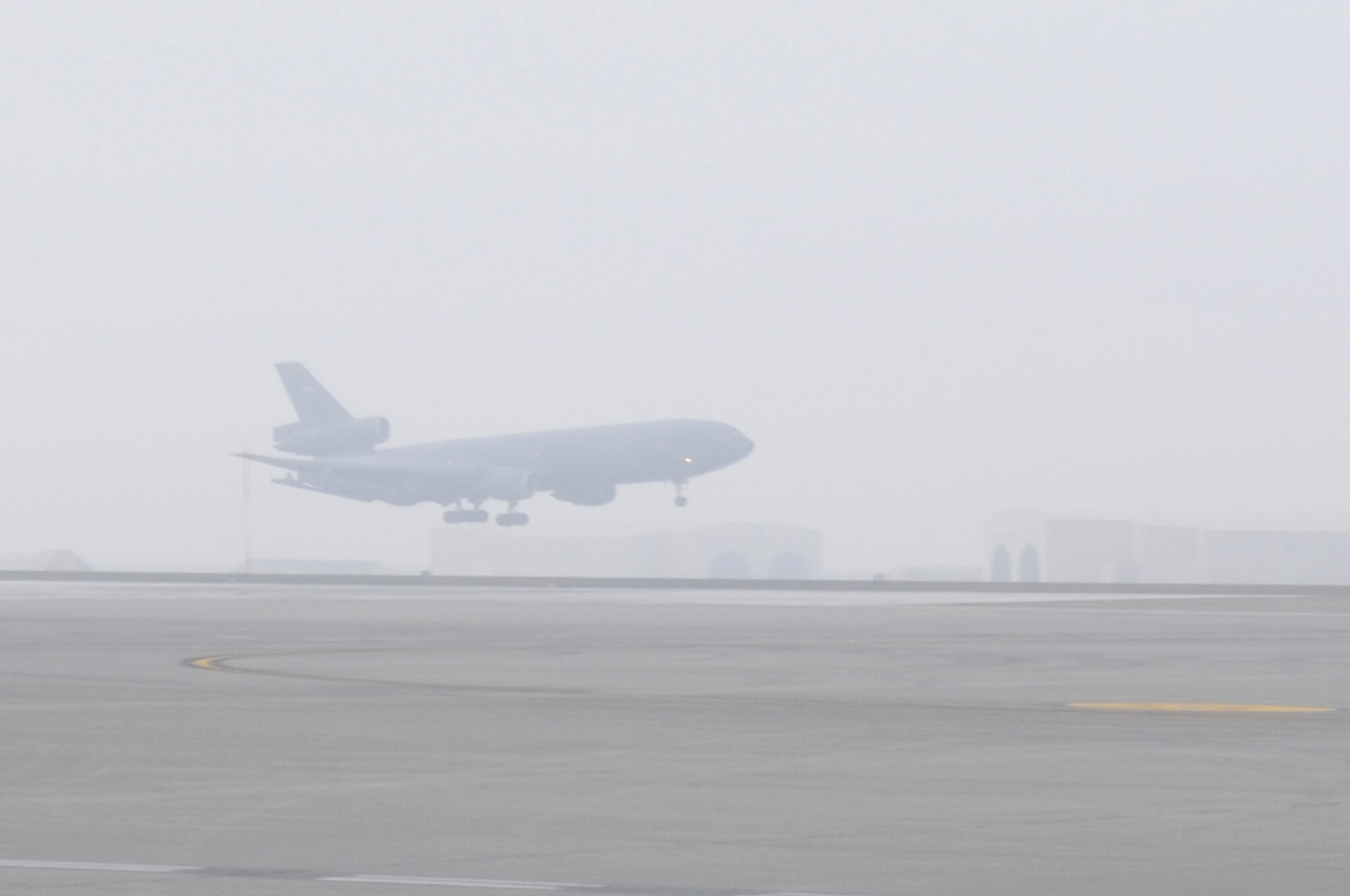 SOUTHWEST ASIA - A KC-10 Extender comes in for a landing at the 380th Air Expeditionary Wing through a haze of fog, Jan 28. The 380th AEW stands mission ready no matter the weather conditions. (U.S. Air Force photo by Senior Airman Brian J. Ellis) (Released)
