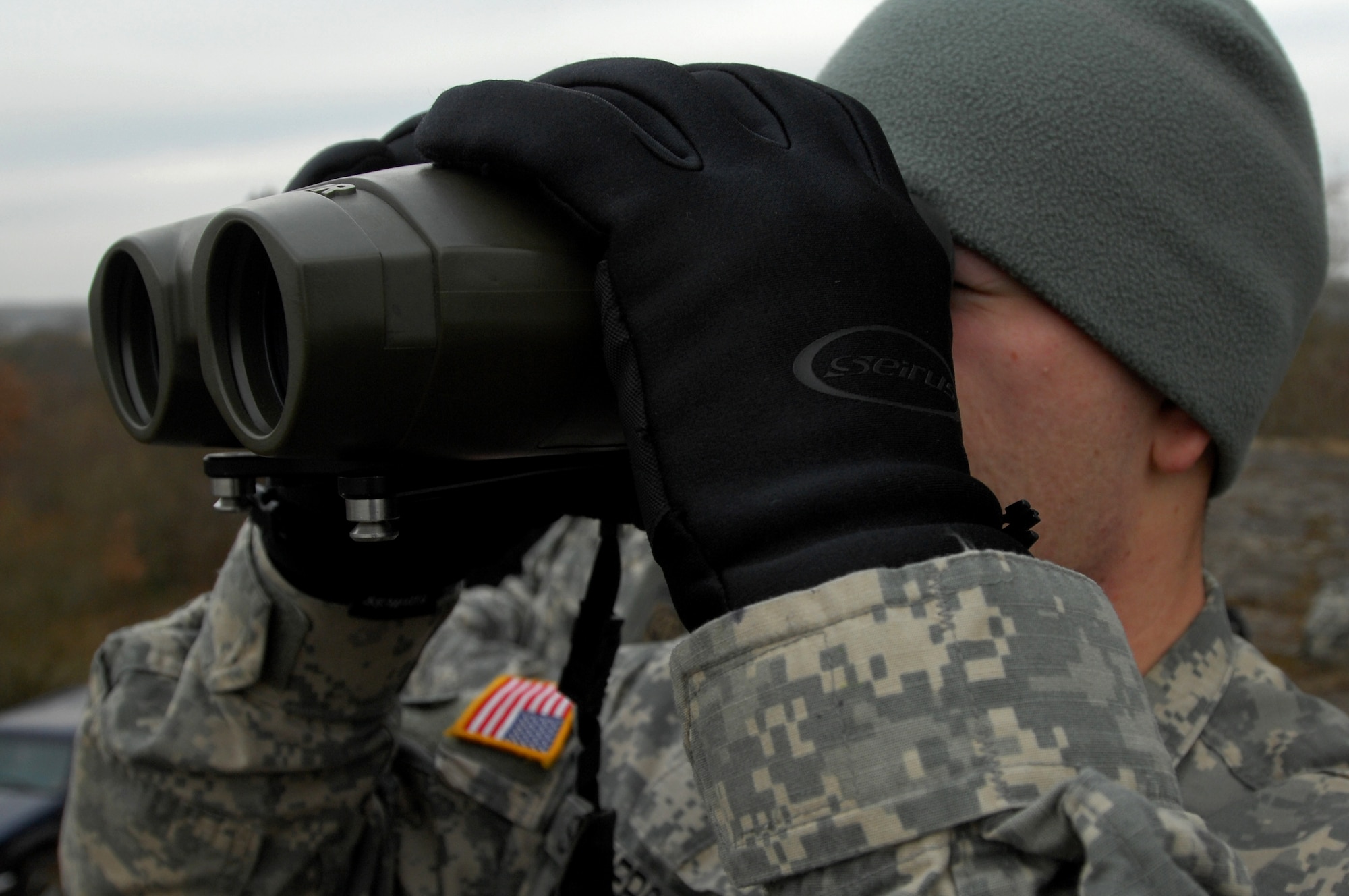 Army Spc. Zach Sanderson, Joint Fire Observer, uses viper binoculars to observer an enemy target during a Joint Fire observers and Joint Terminal Air Controllers exercise, Jan. 29, 2009, in Southern France. Army JFOs and Air Force JTAC students worked together during the exercise to reach mission success. (U.S. Air Force photo by Airman 1st Class Kenny Holston)